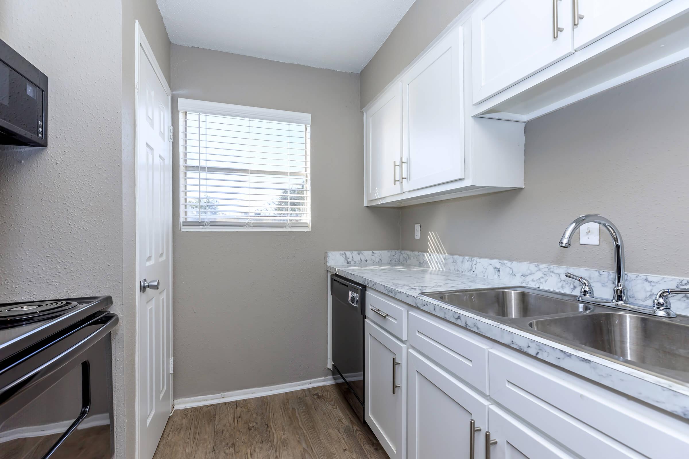 a kitchen with a sink and a mirror