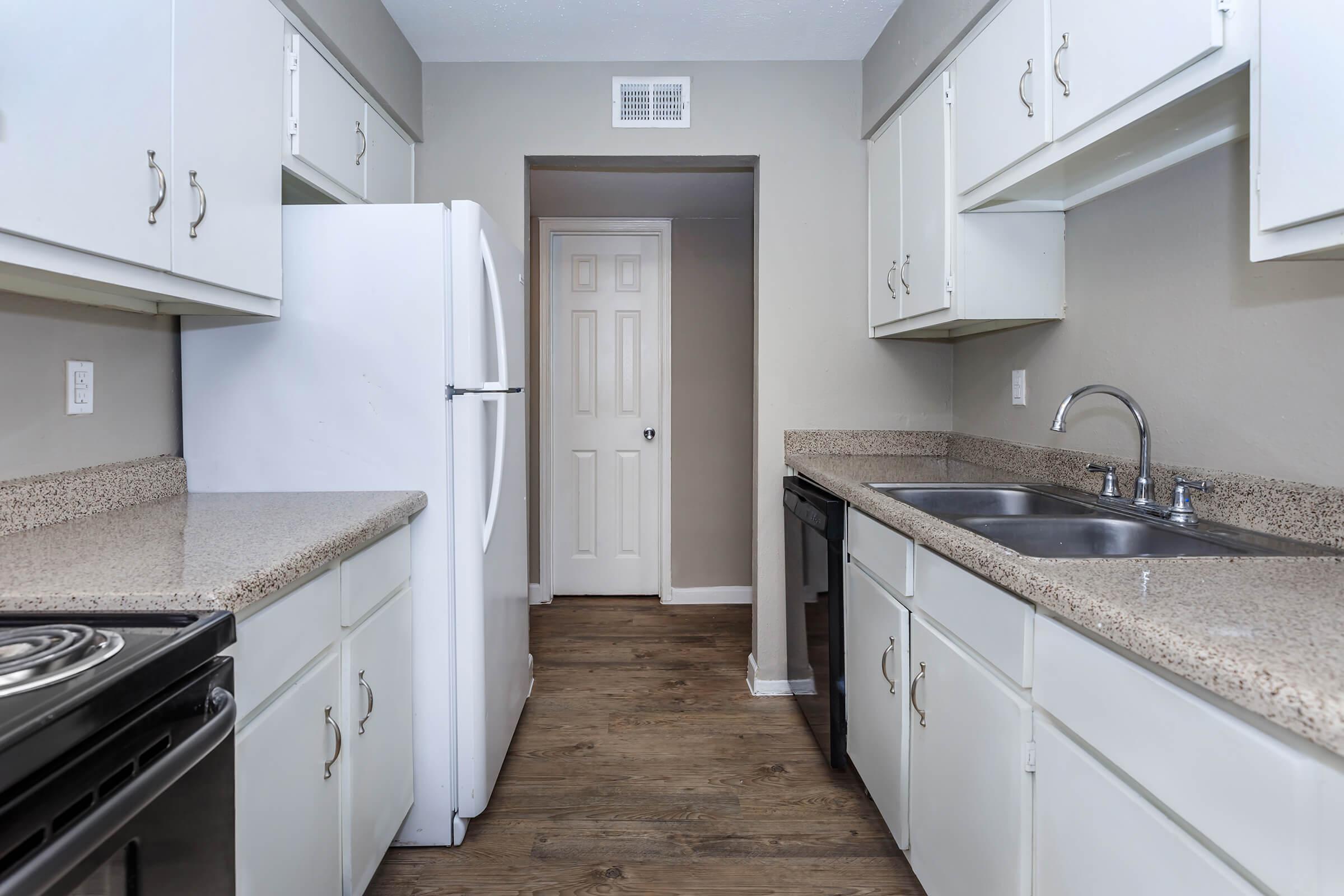 a kitchen with a stove sink and refrigerator