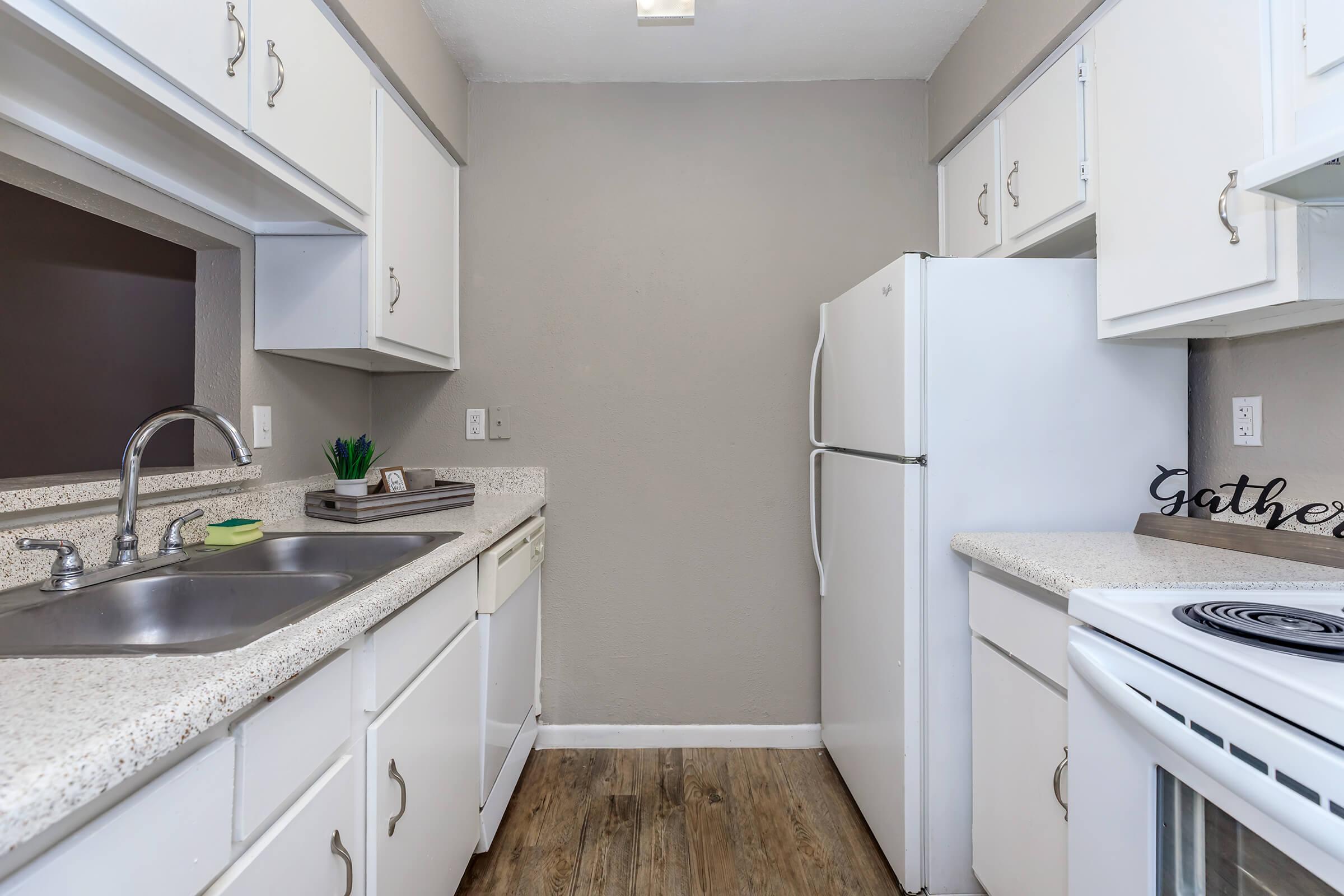 a kitchen with a stove sink and refrigerator