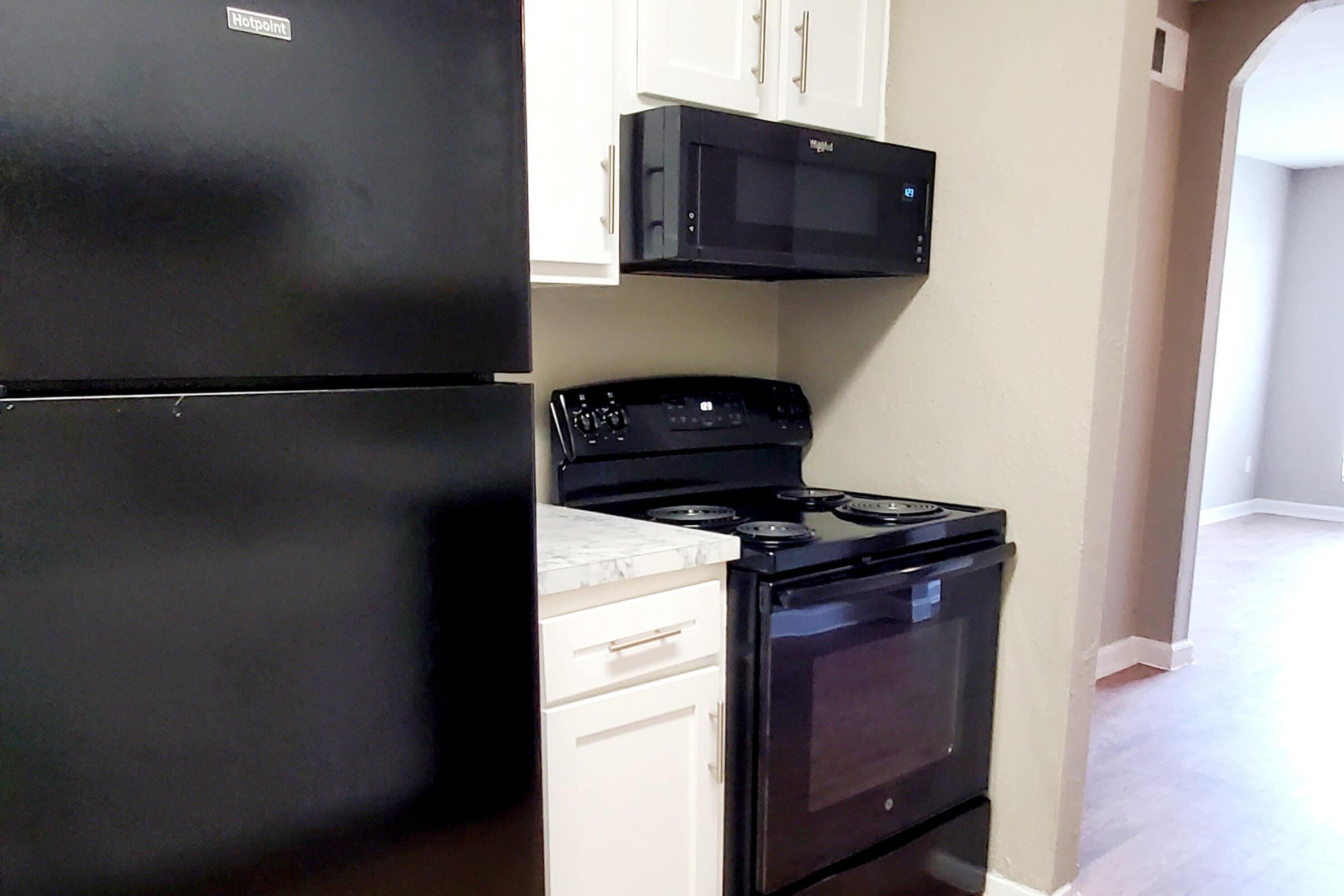 a kitchen with a stove top oven sitting inside of a refrigerator