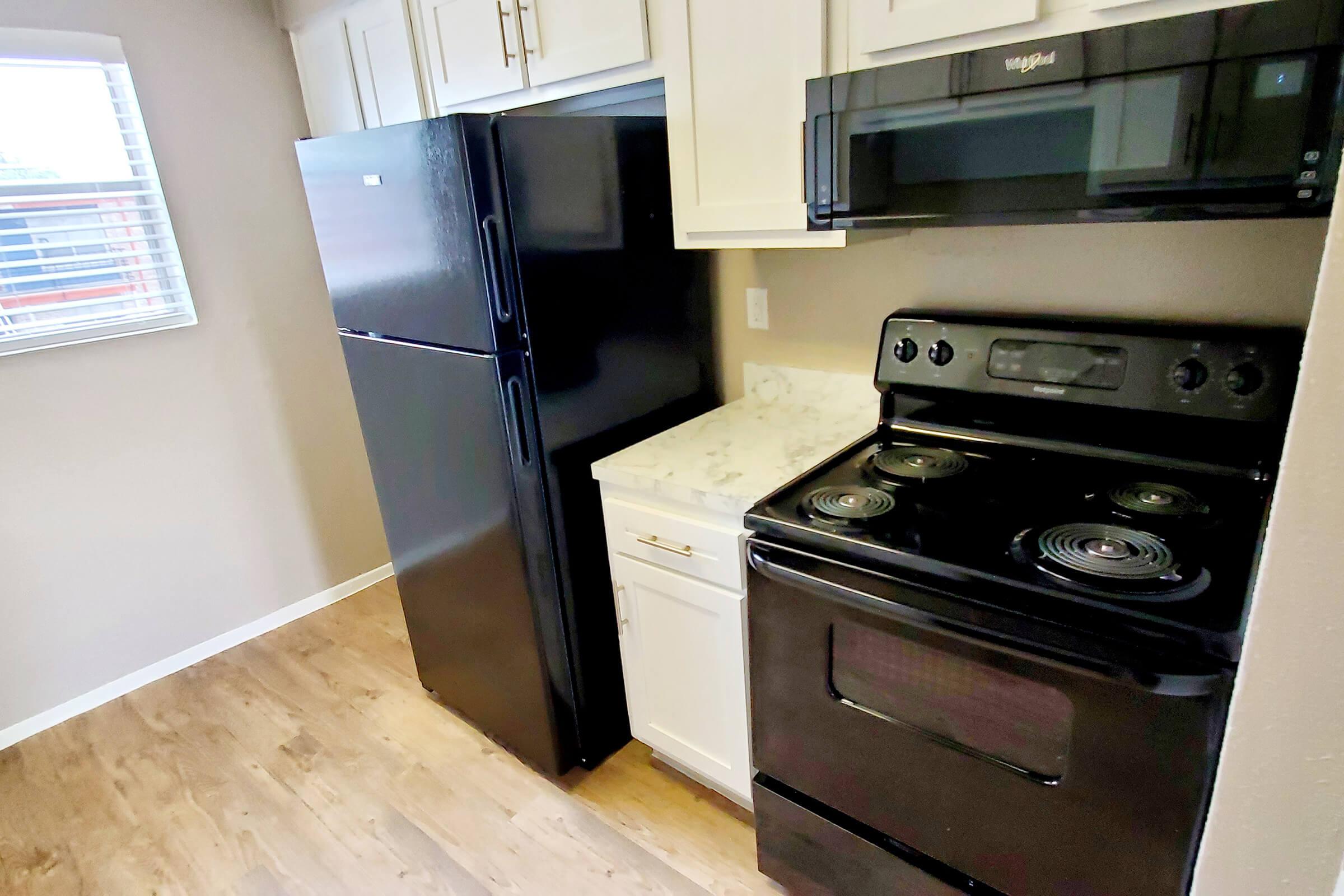 a stove top oven sitting inside of a kitchen