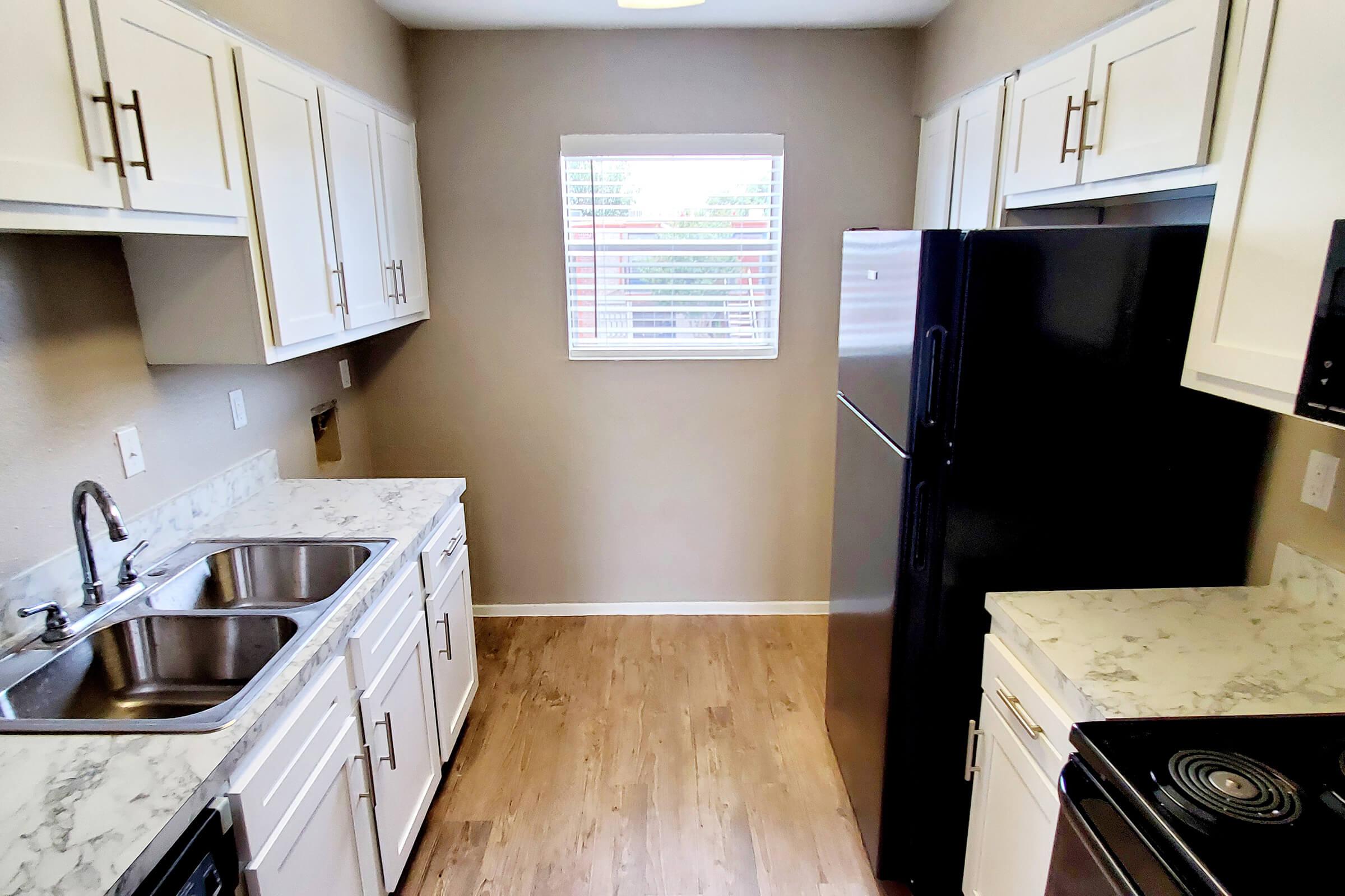 a stove top oven sitting inside of a kitchen