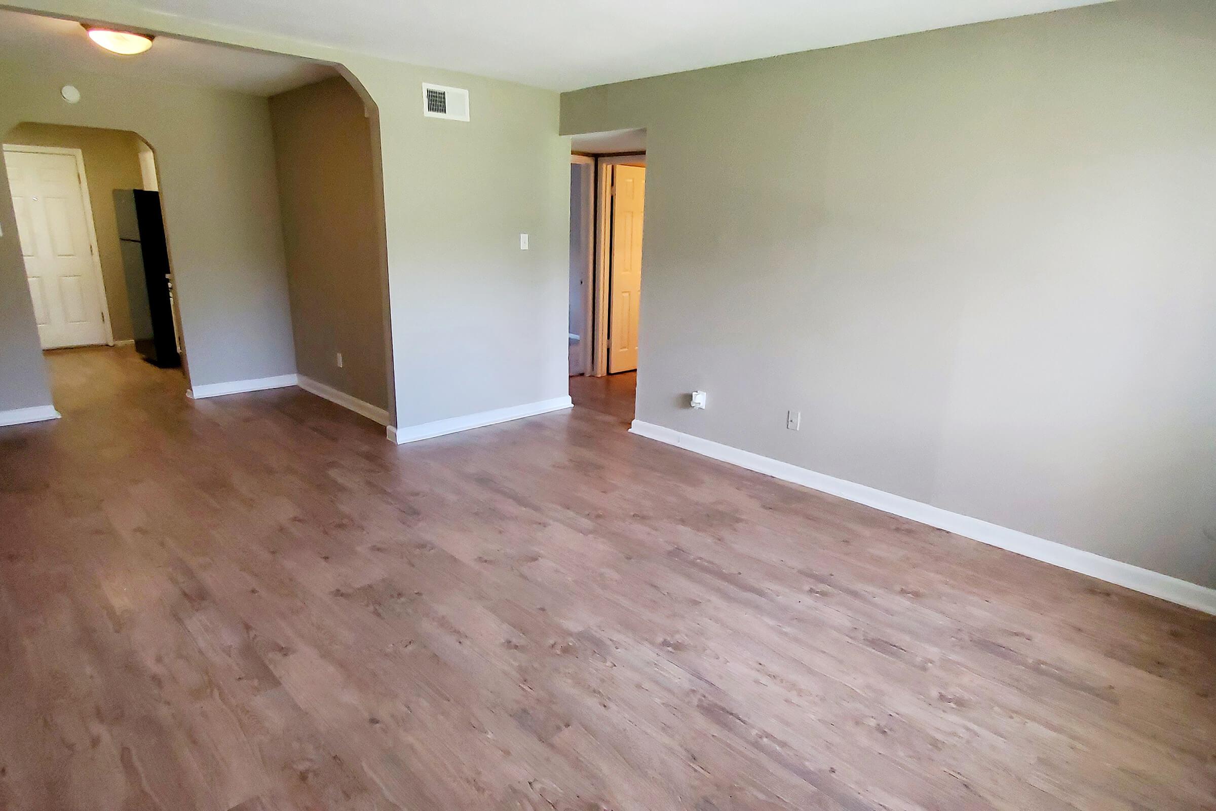 a large empty room with a wooden floor