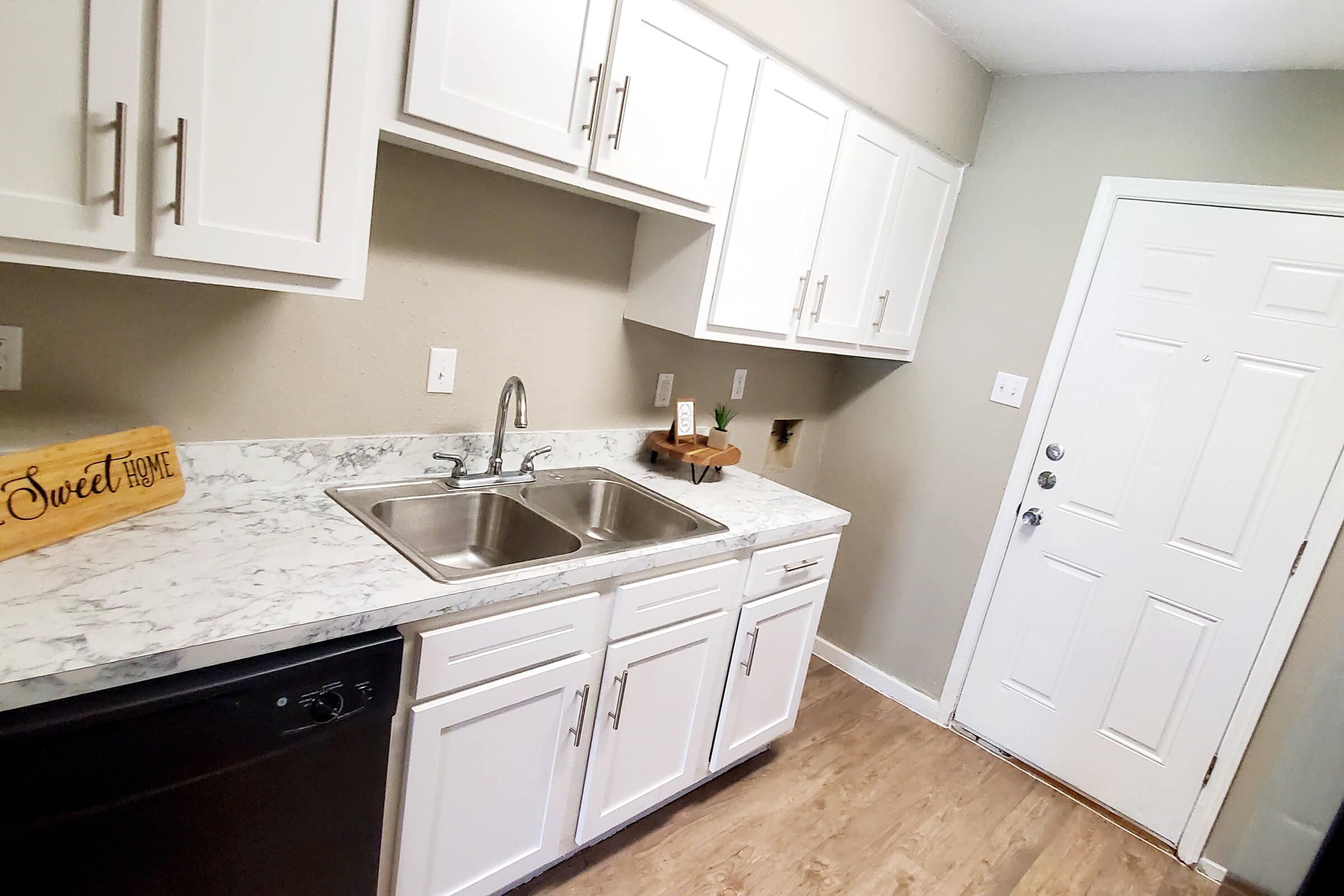 a kitchen with a sink and a mirror