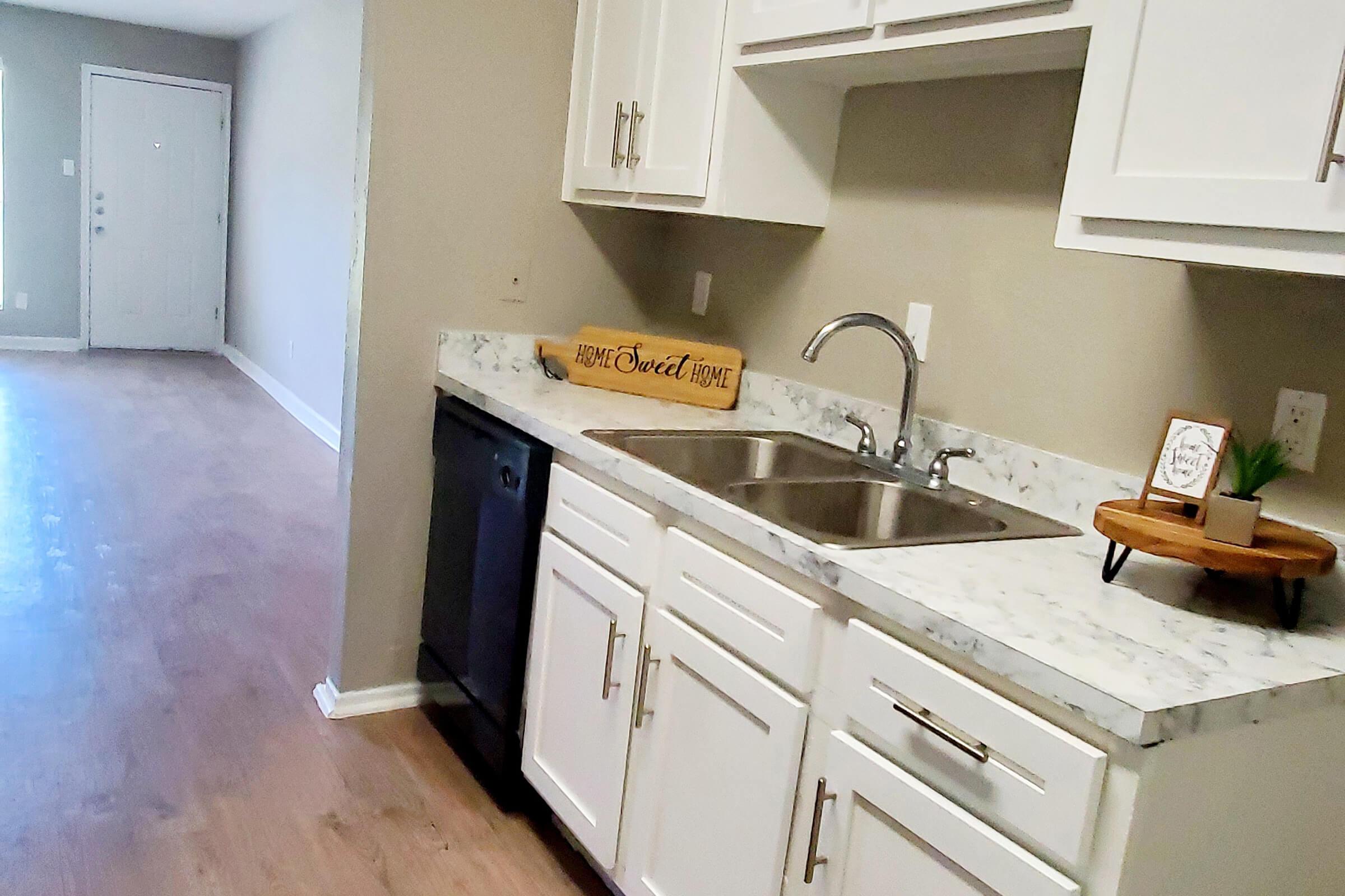 a kitchen with a sink and a microwave