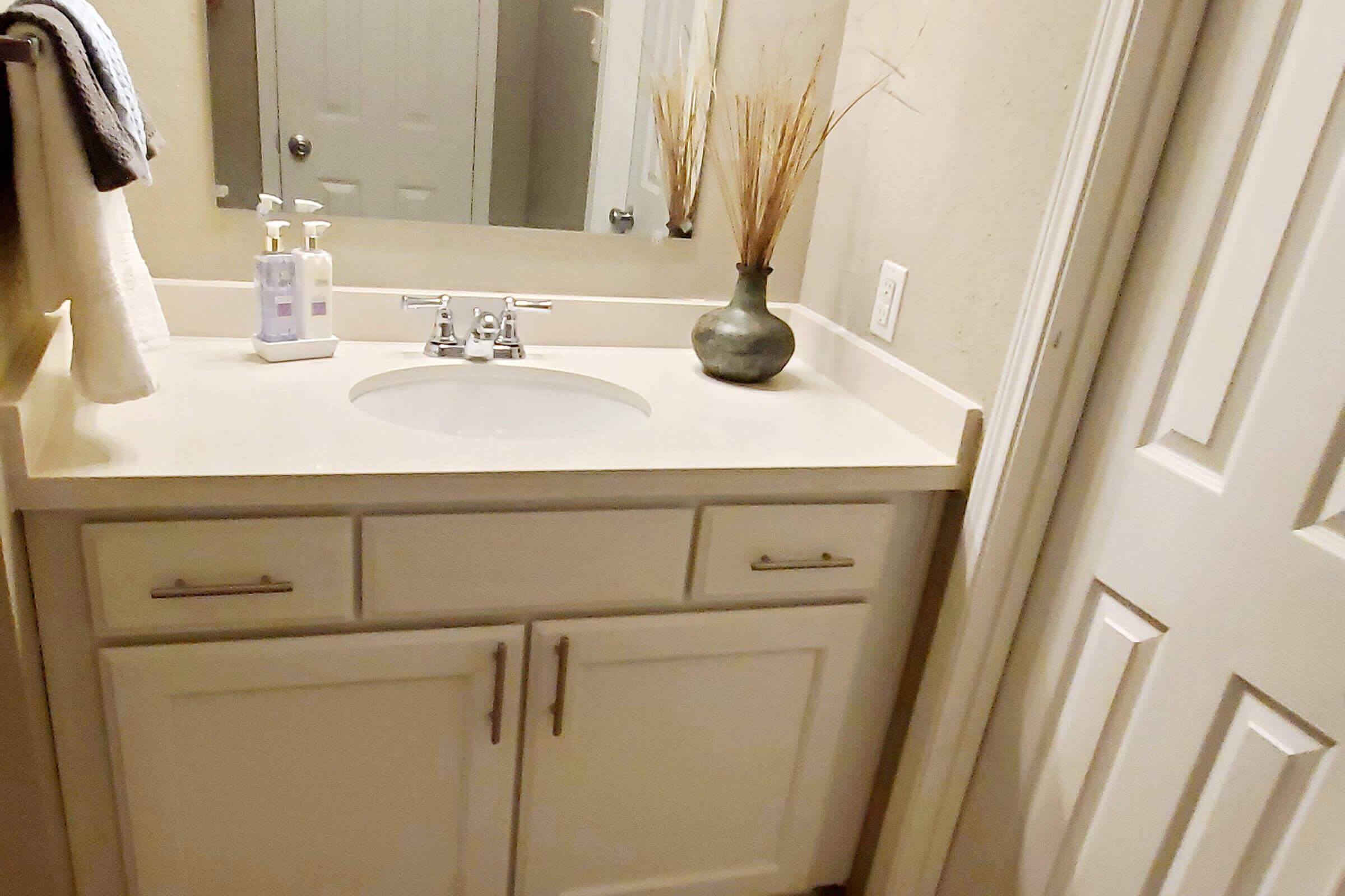 a kitchen with a sink and a mirror