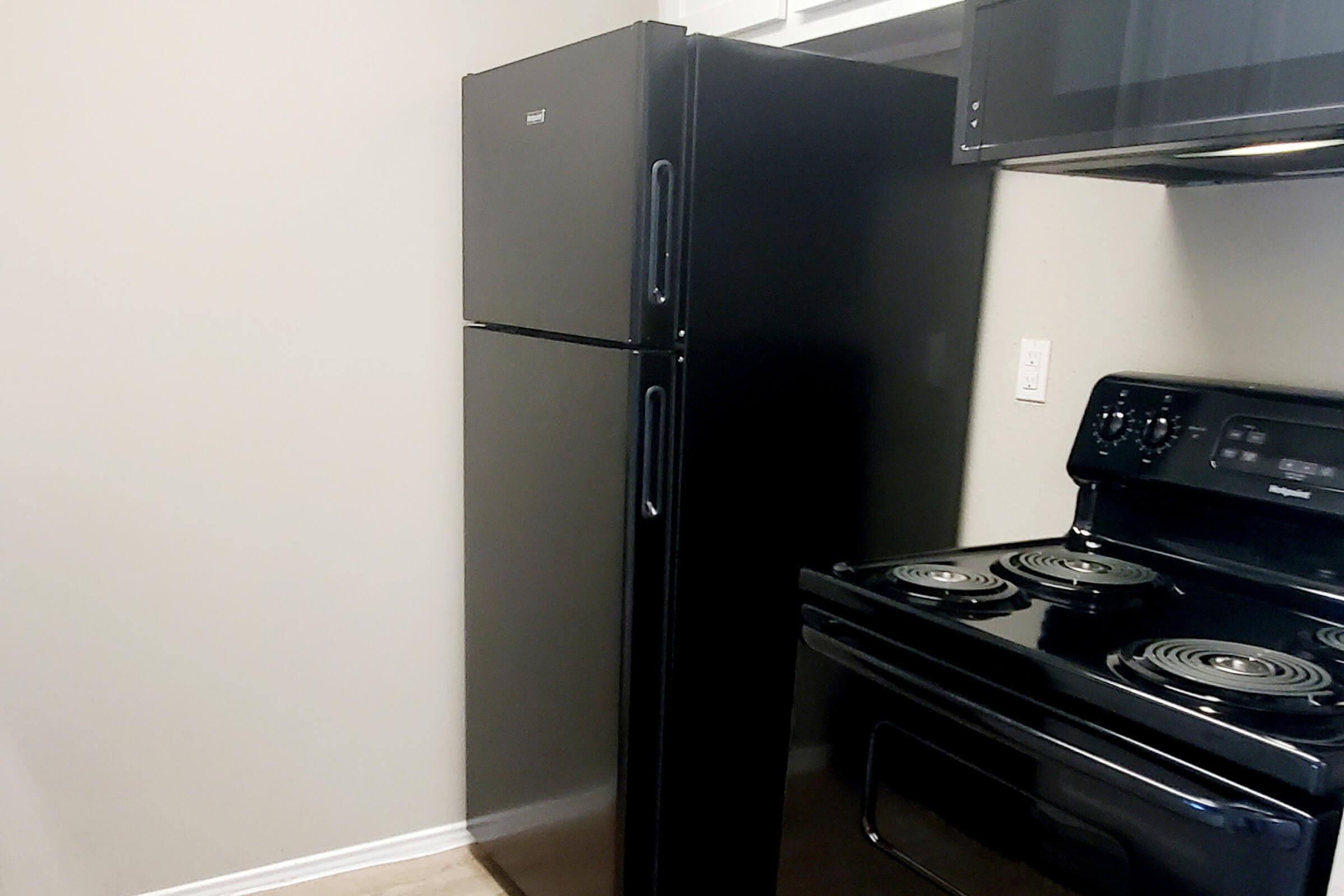 a stove top oven sitting inside of a refrigerator