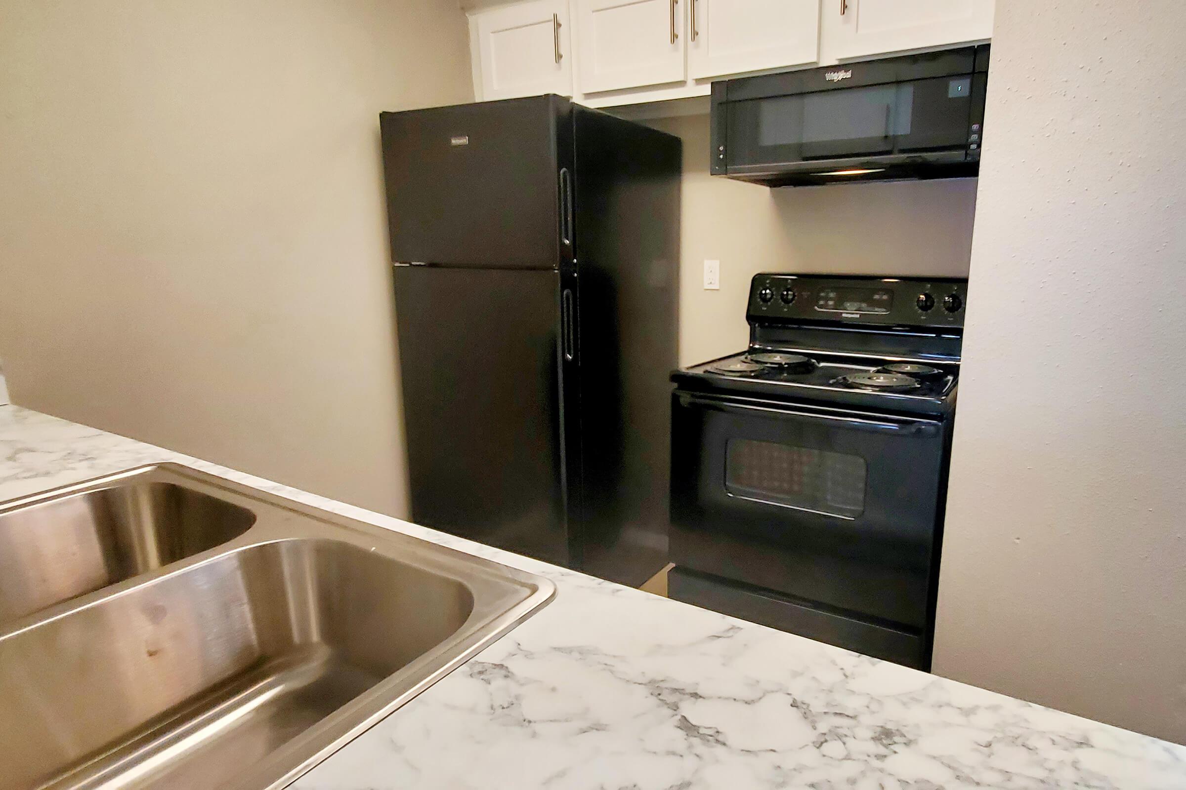 a stove top oven sitting inside of a kitchen