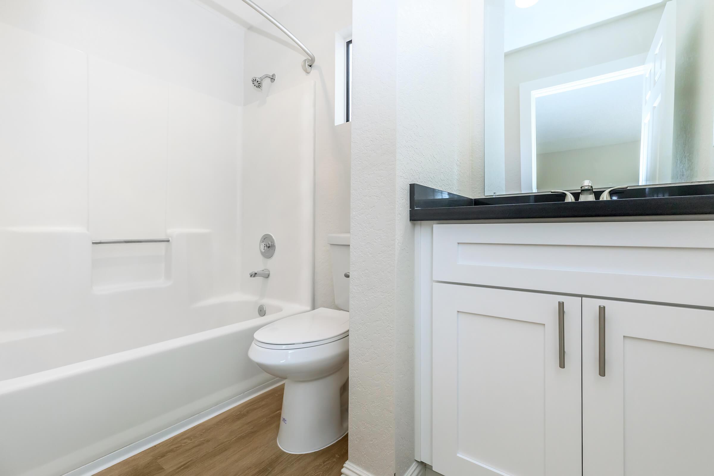 a white tub sitting next to a sink