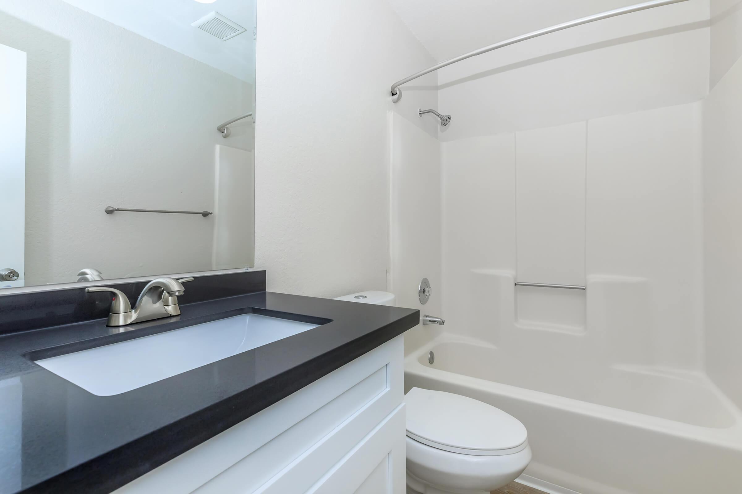 a large white tub sitting next to a sink