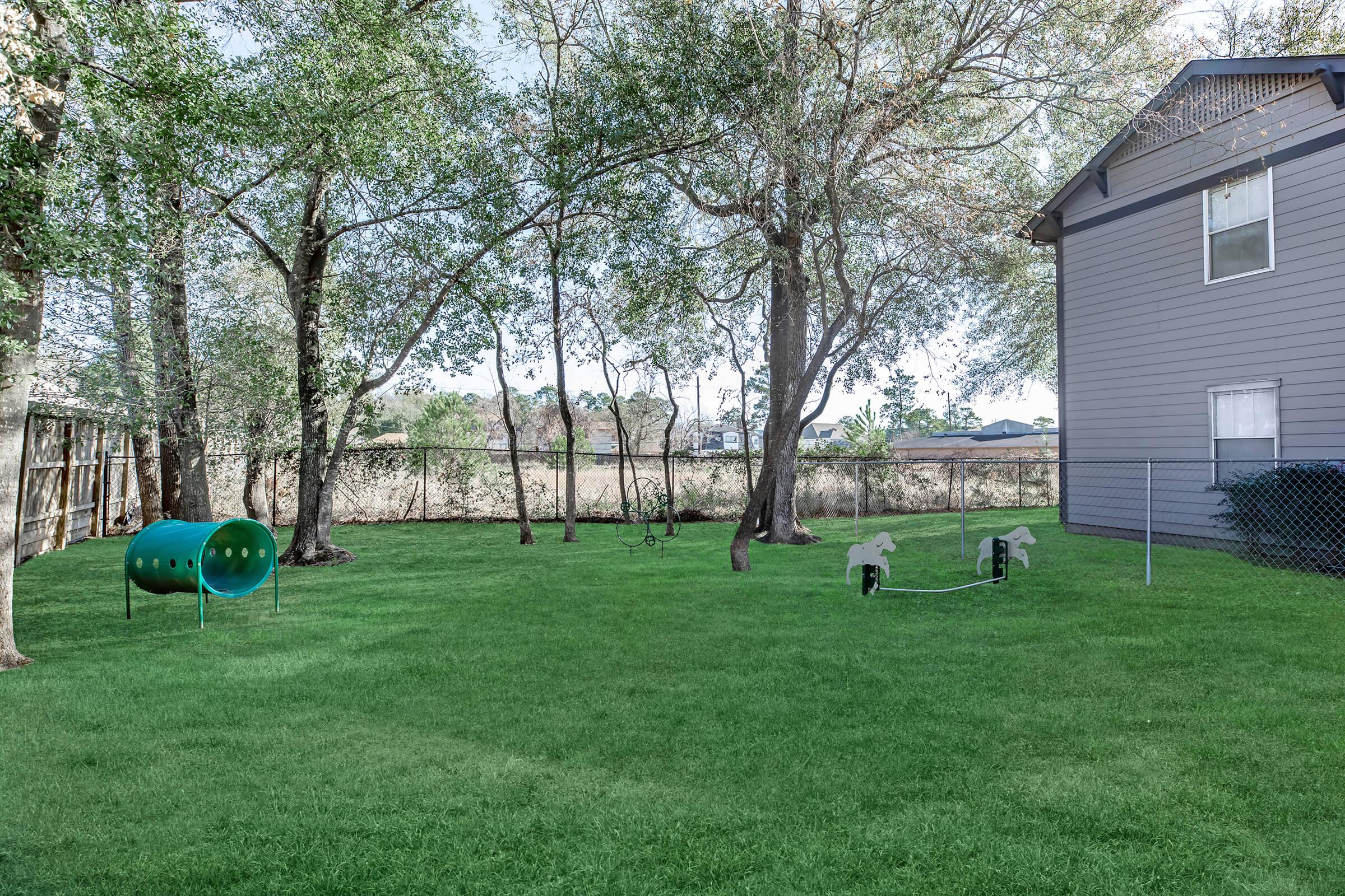 a large green field in front of a house