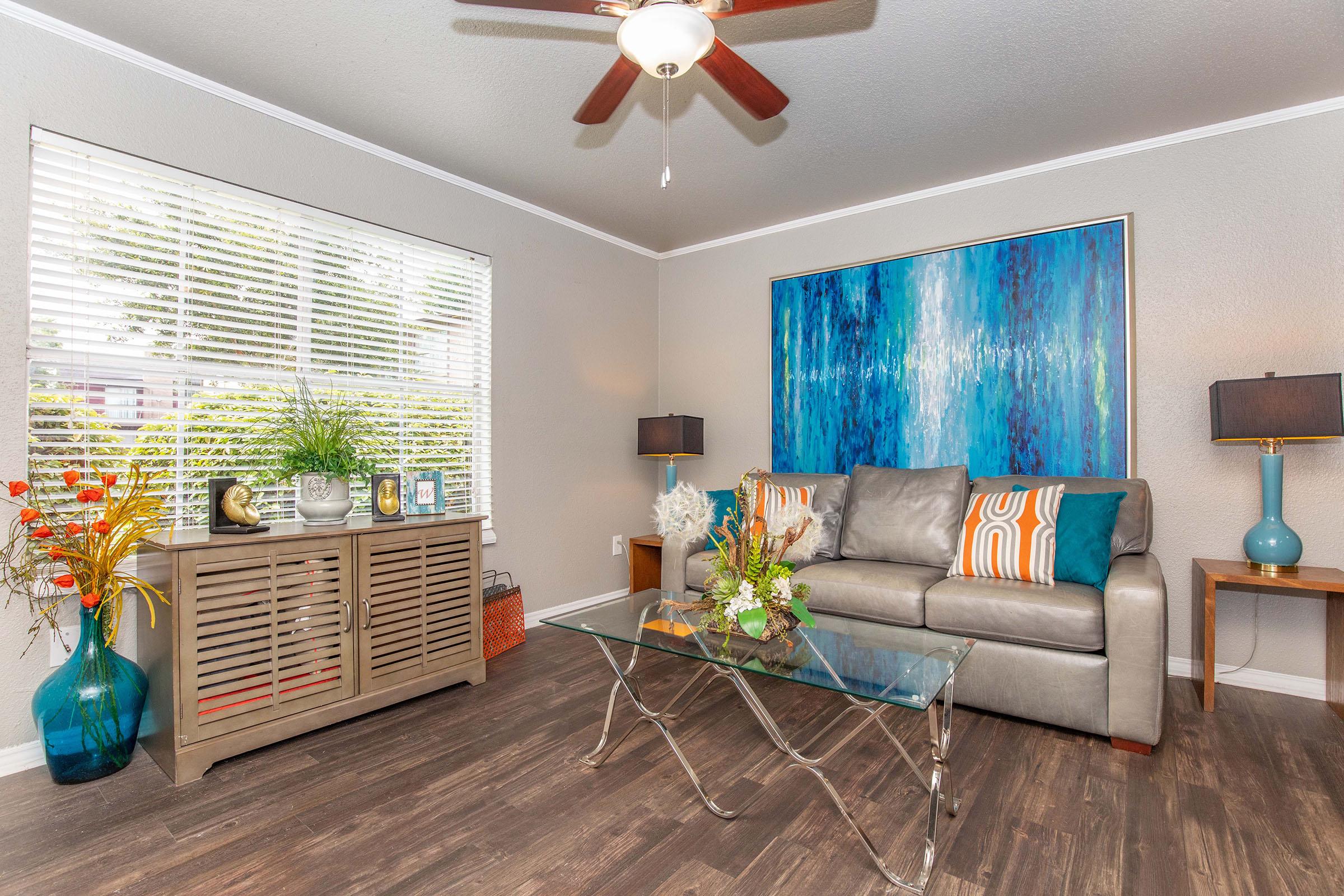 a living room filled with furniture and a large window