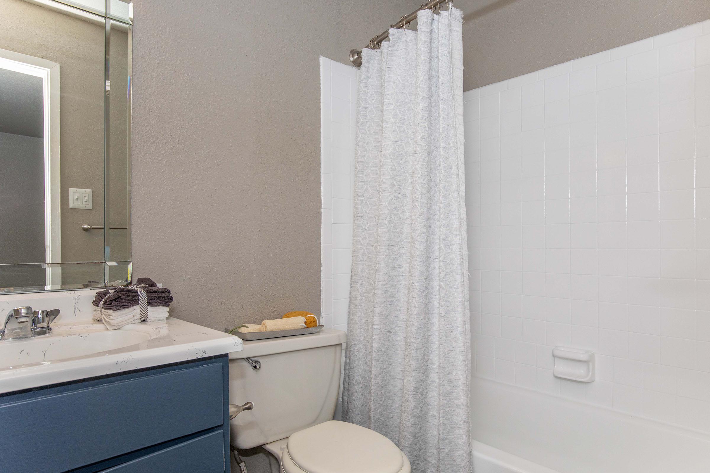 a sink and a white tub sitting next to a shower