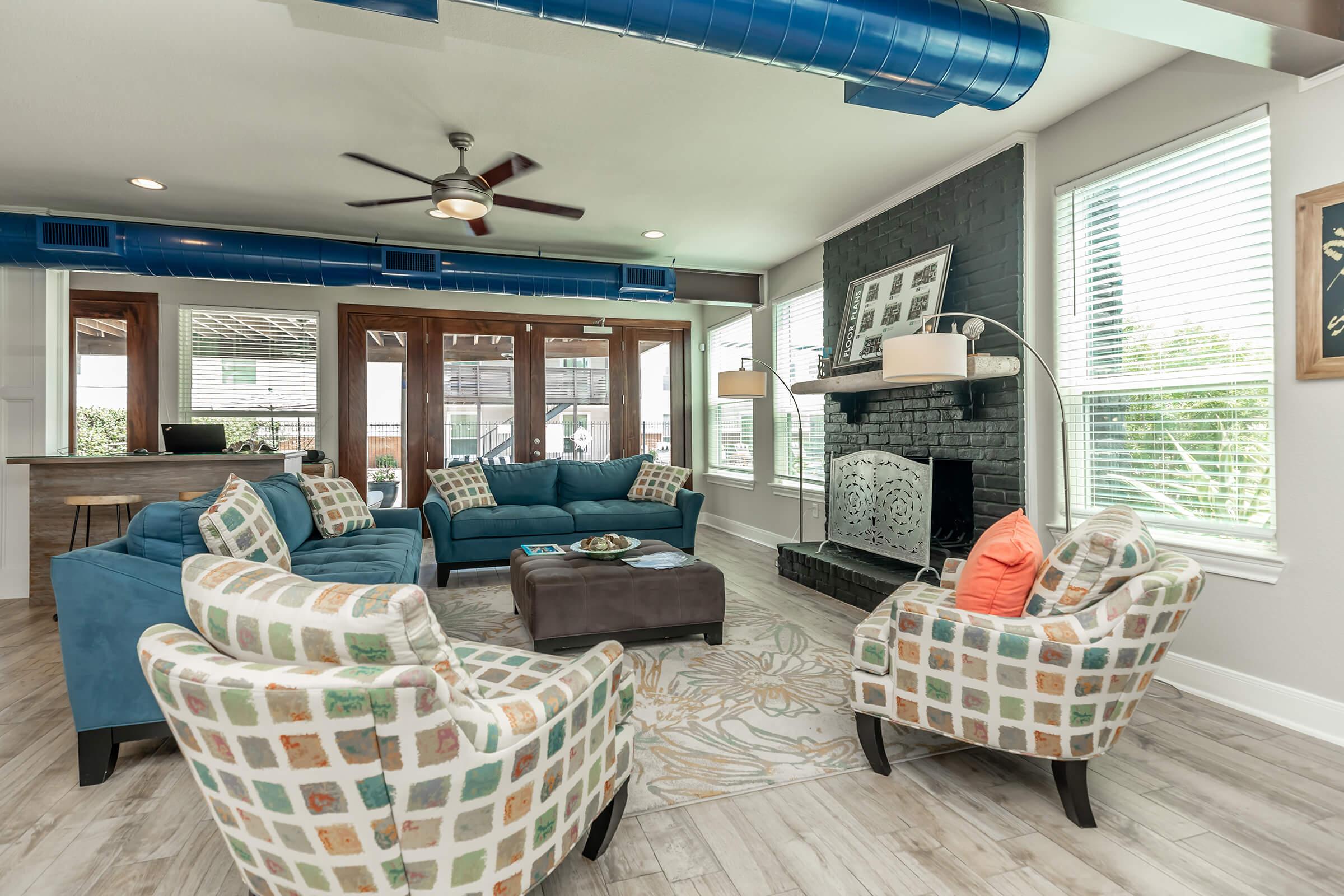 a living room filled with furniture and a large window