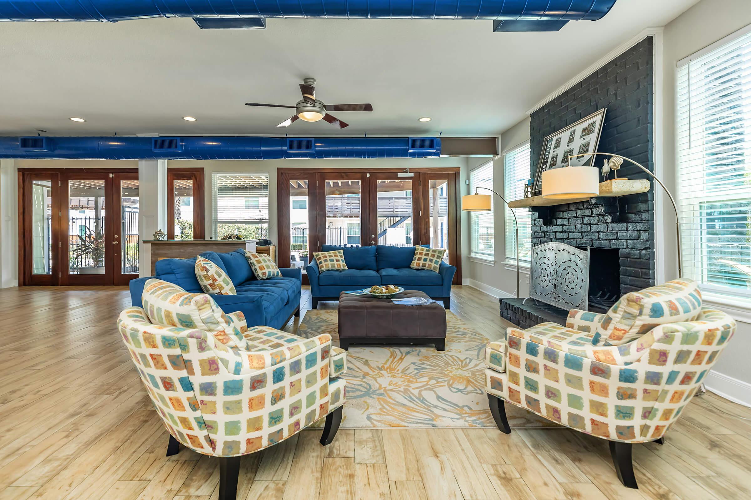 a living room filled with furniture and a large window