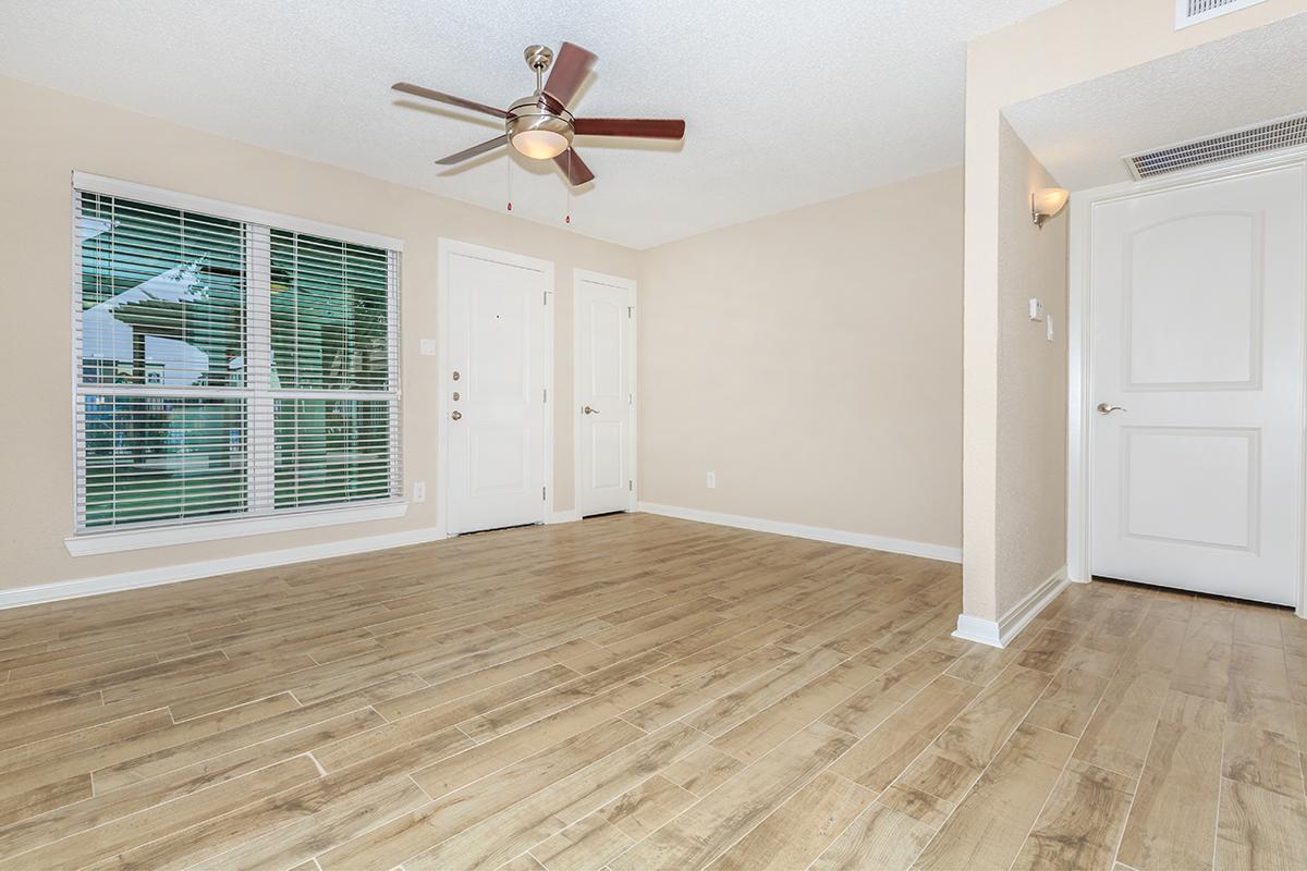 a large empty room with a wooden floor