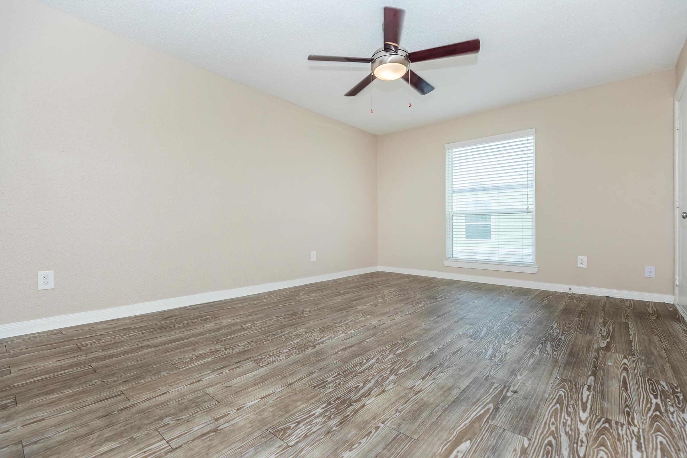 a bedroom with a wooden floor