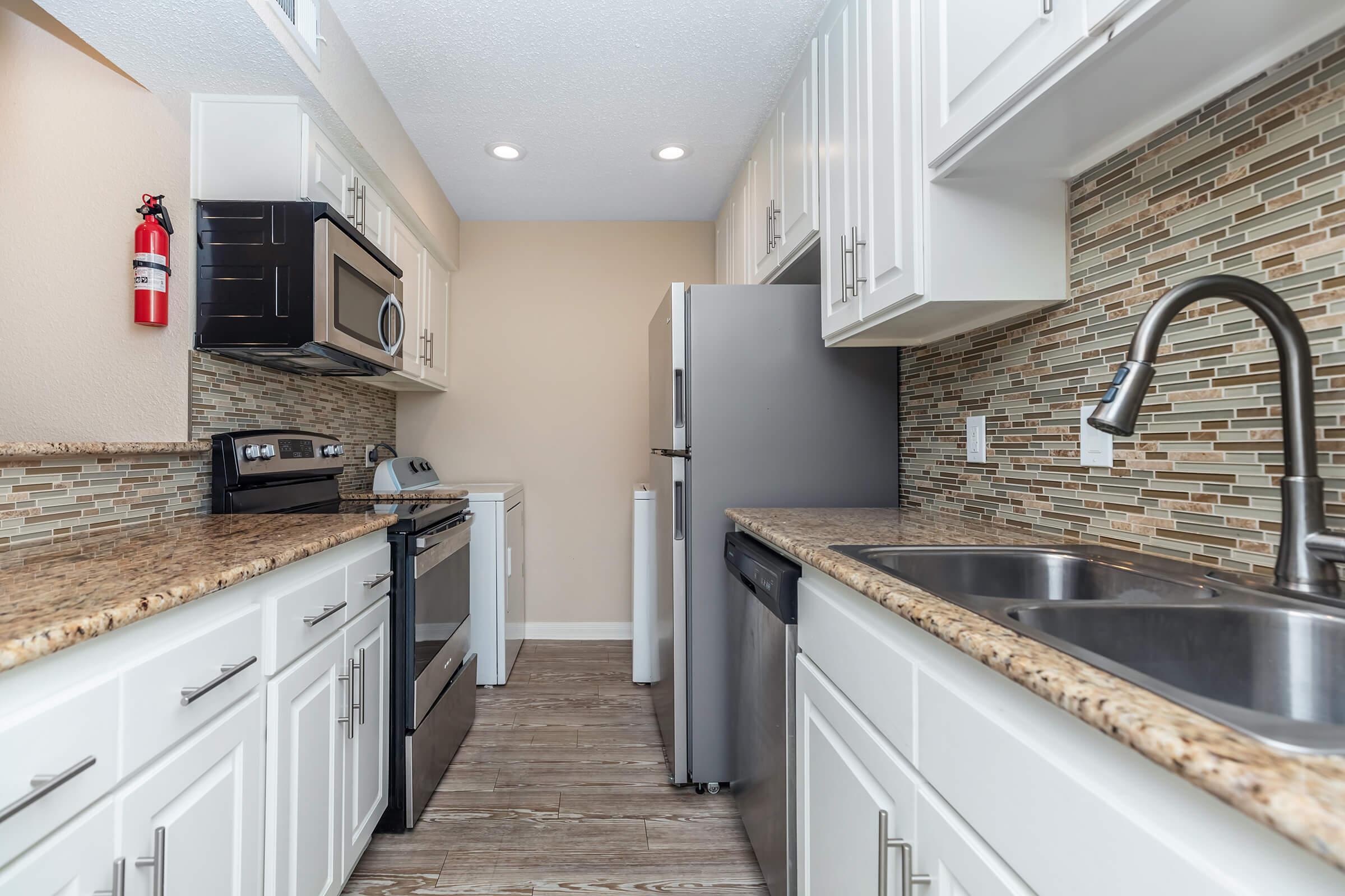 a large kitchen with stainless steel appliances