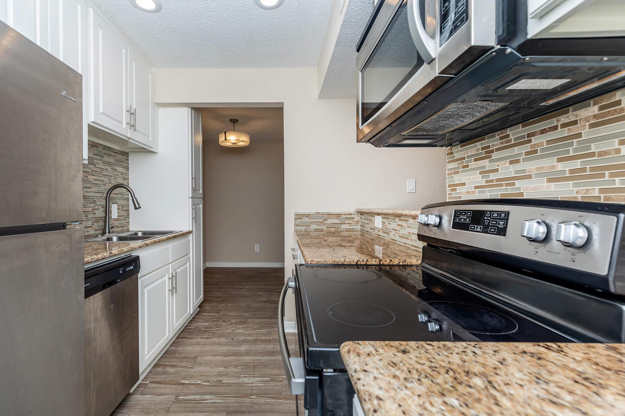 a stove top oven sitting inside of a kitchen