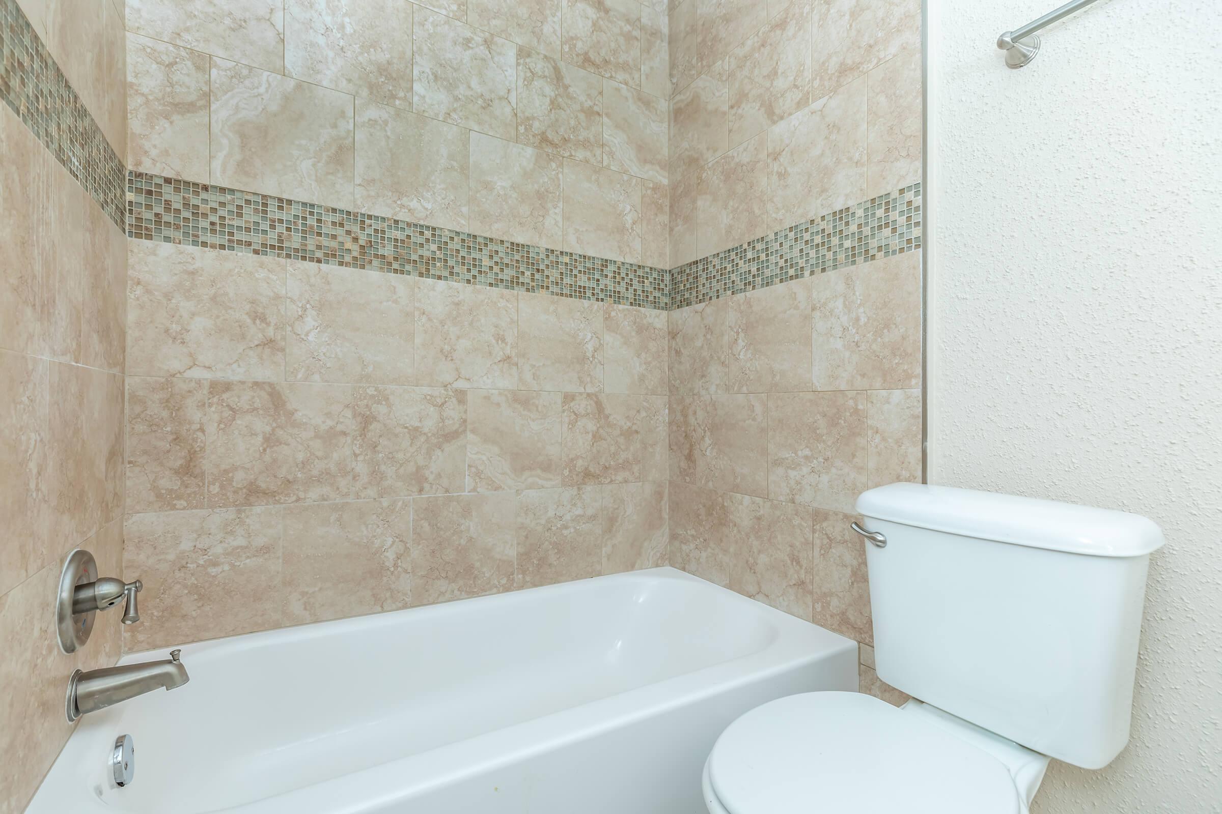 a close up of pink tub and sink