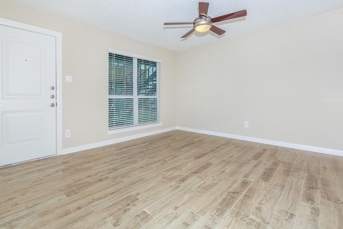 a large empty room with a wooden floor