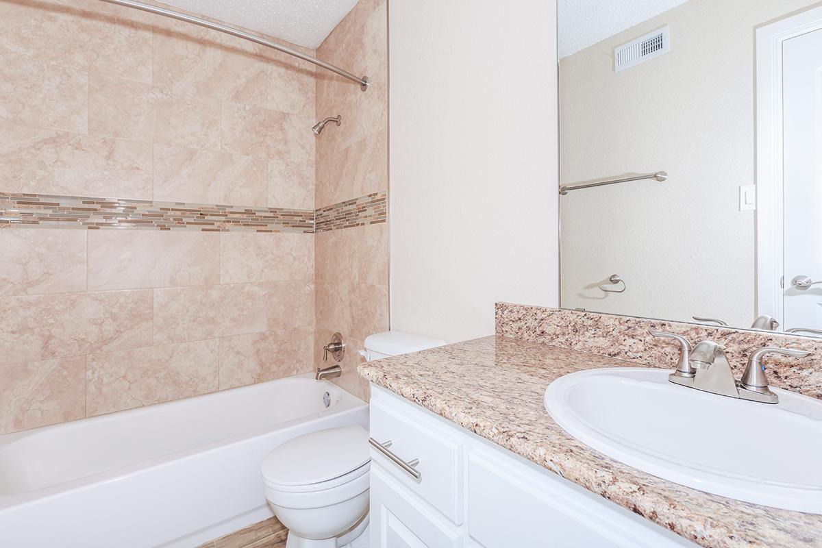 a large white tub next to a sink