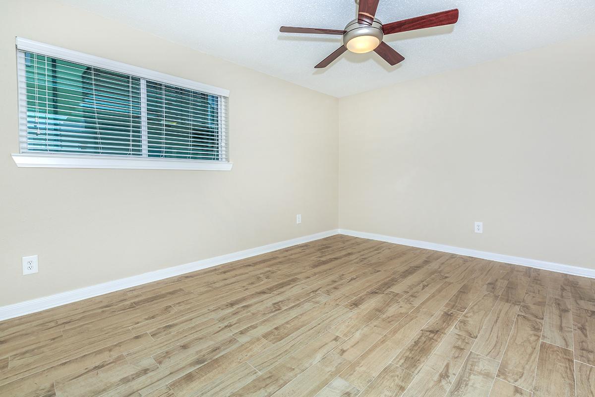 a bedroom with a wooden floor