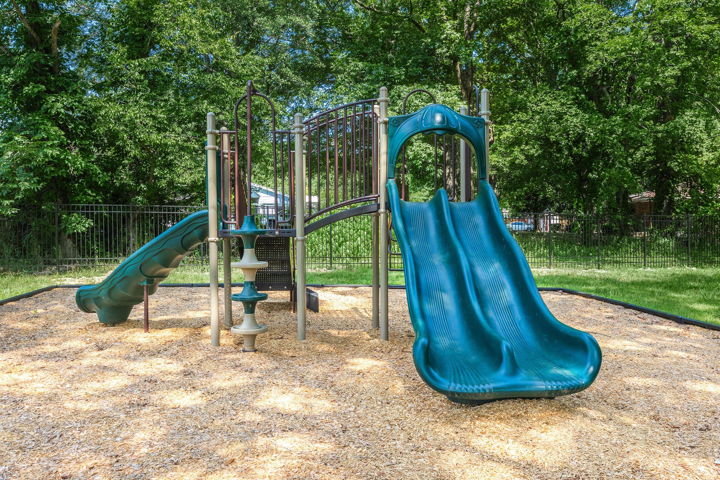 a blue chair in a park