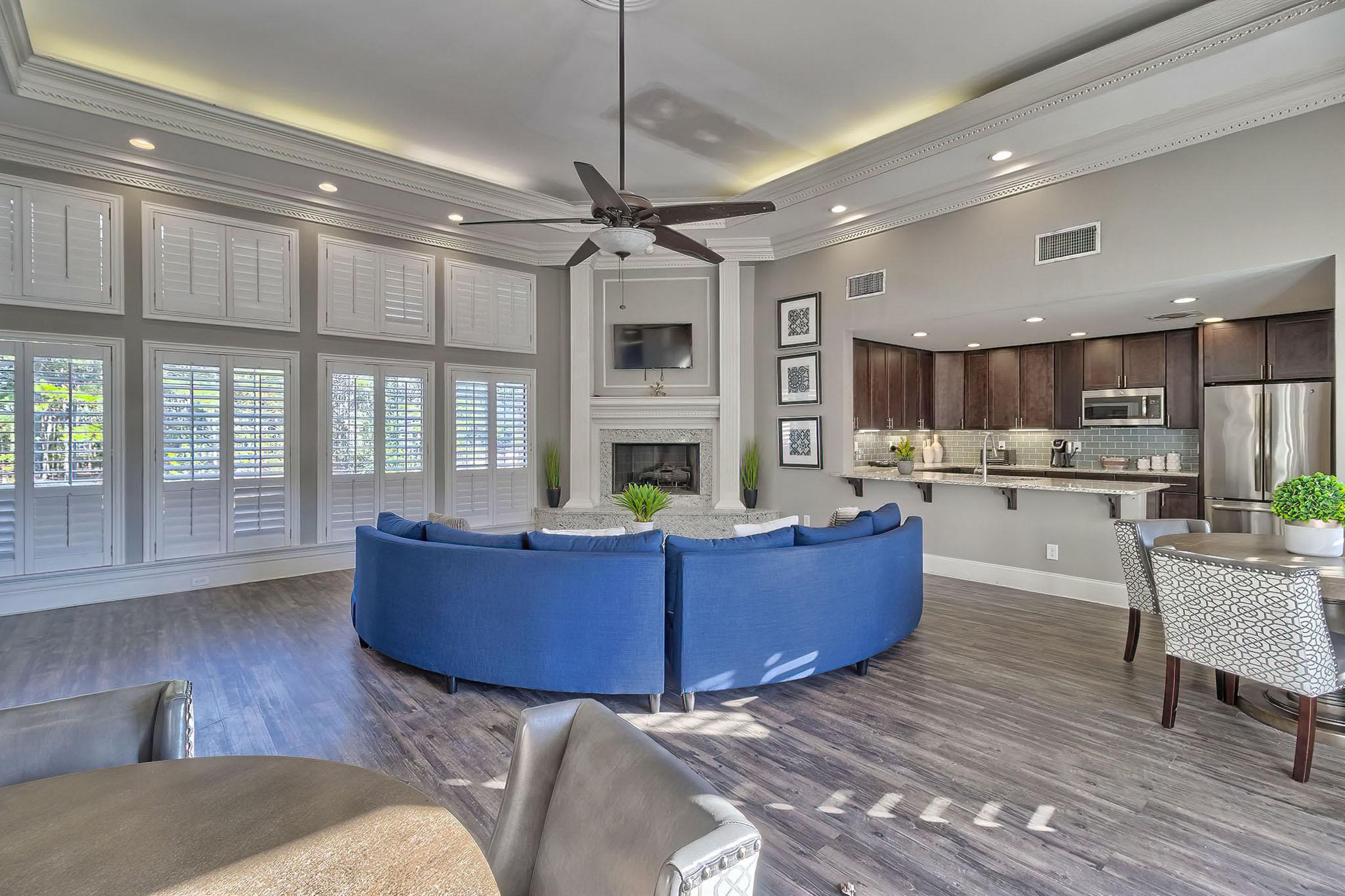 a living room filled with furniture and a large window