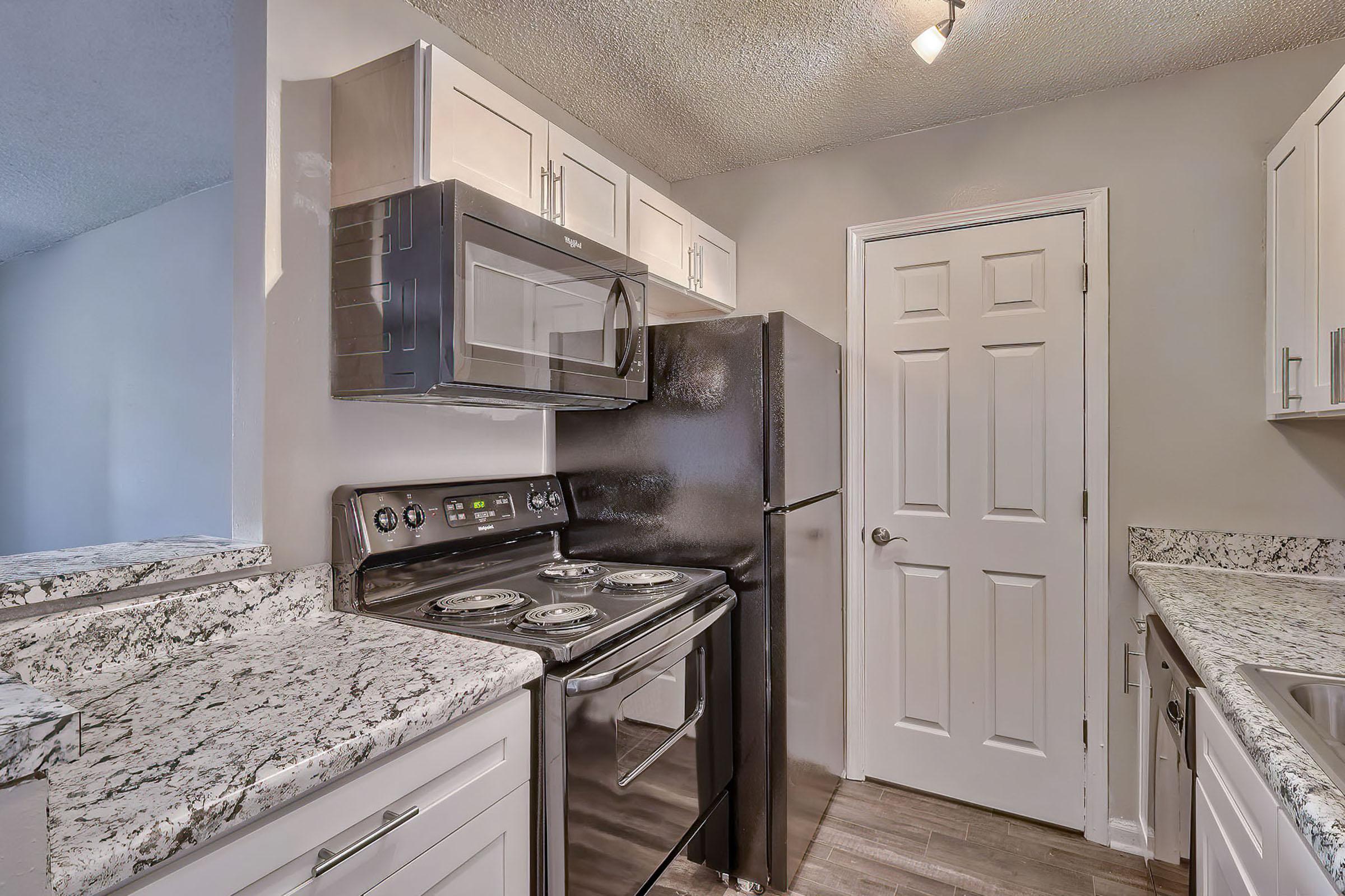 a kitchen with a stove sink and refrigerator