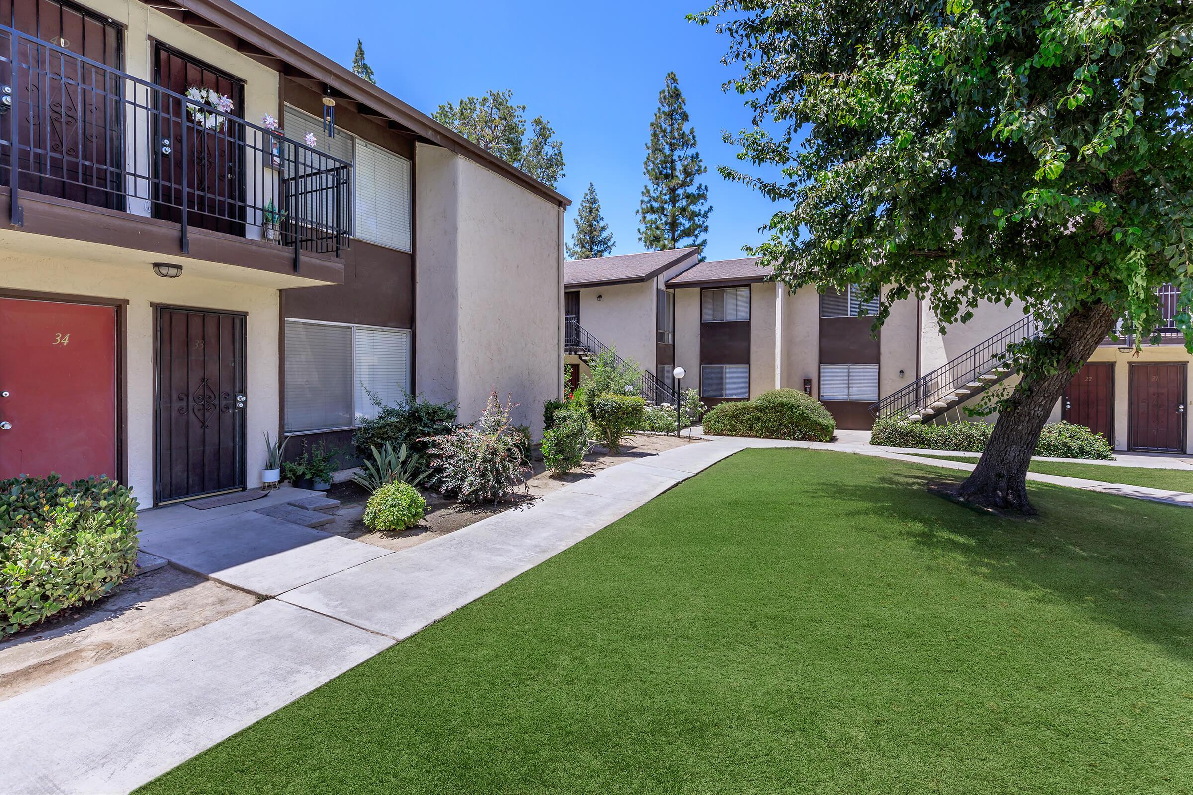 a large lawn in front of a brick building