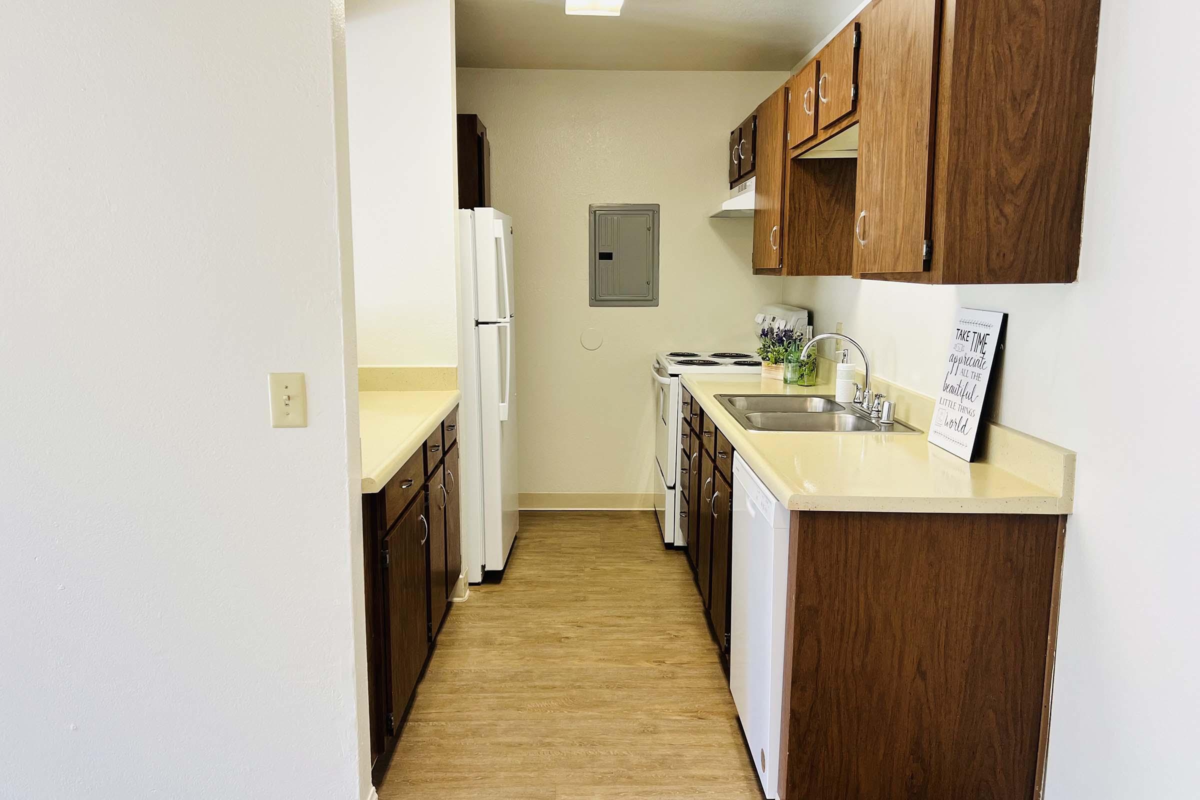 a kitchen with a sink and a refrigerator