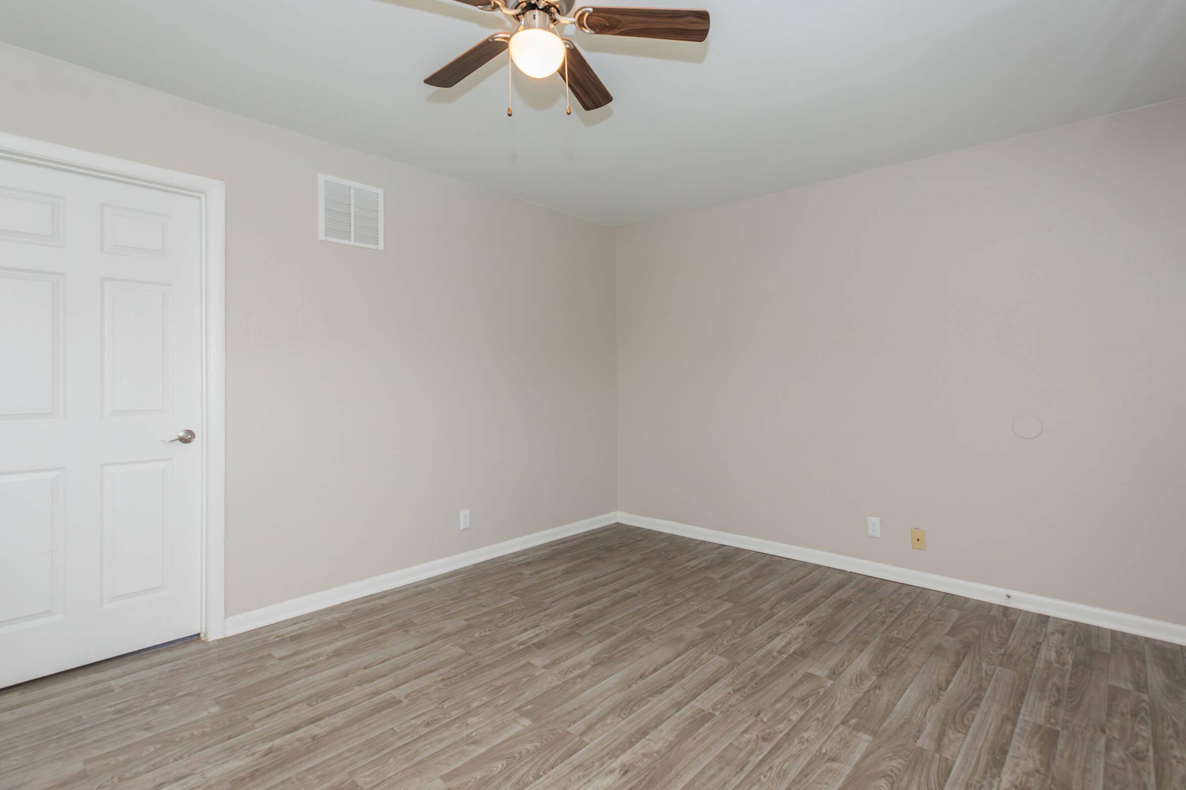 a bedroom with a wood floor