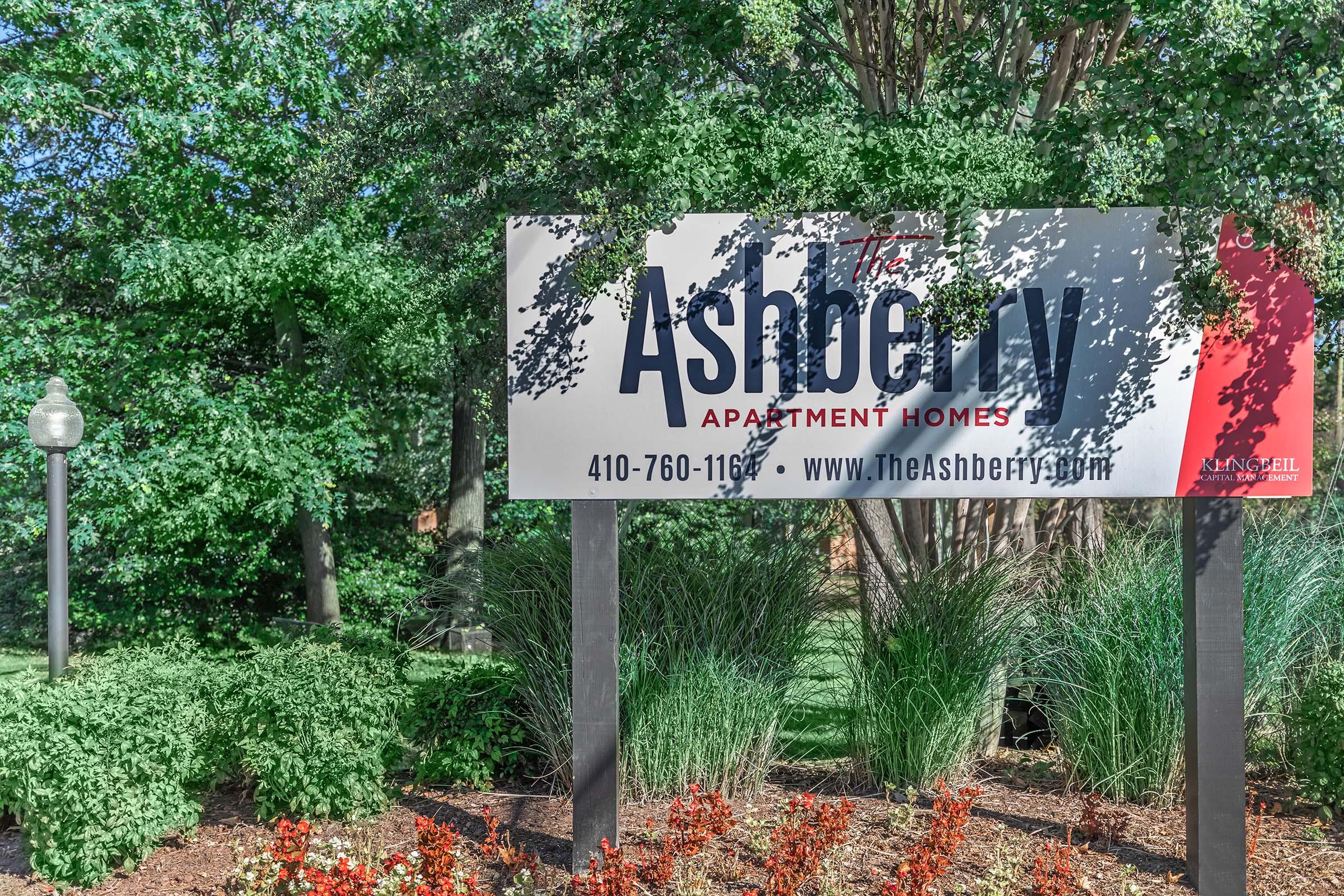 a sign in front of a tree