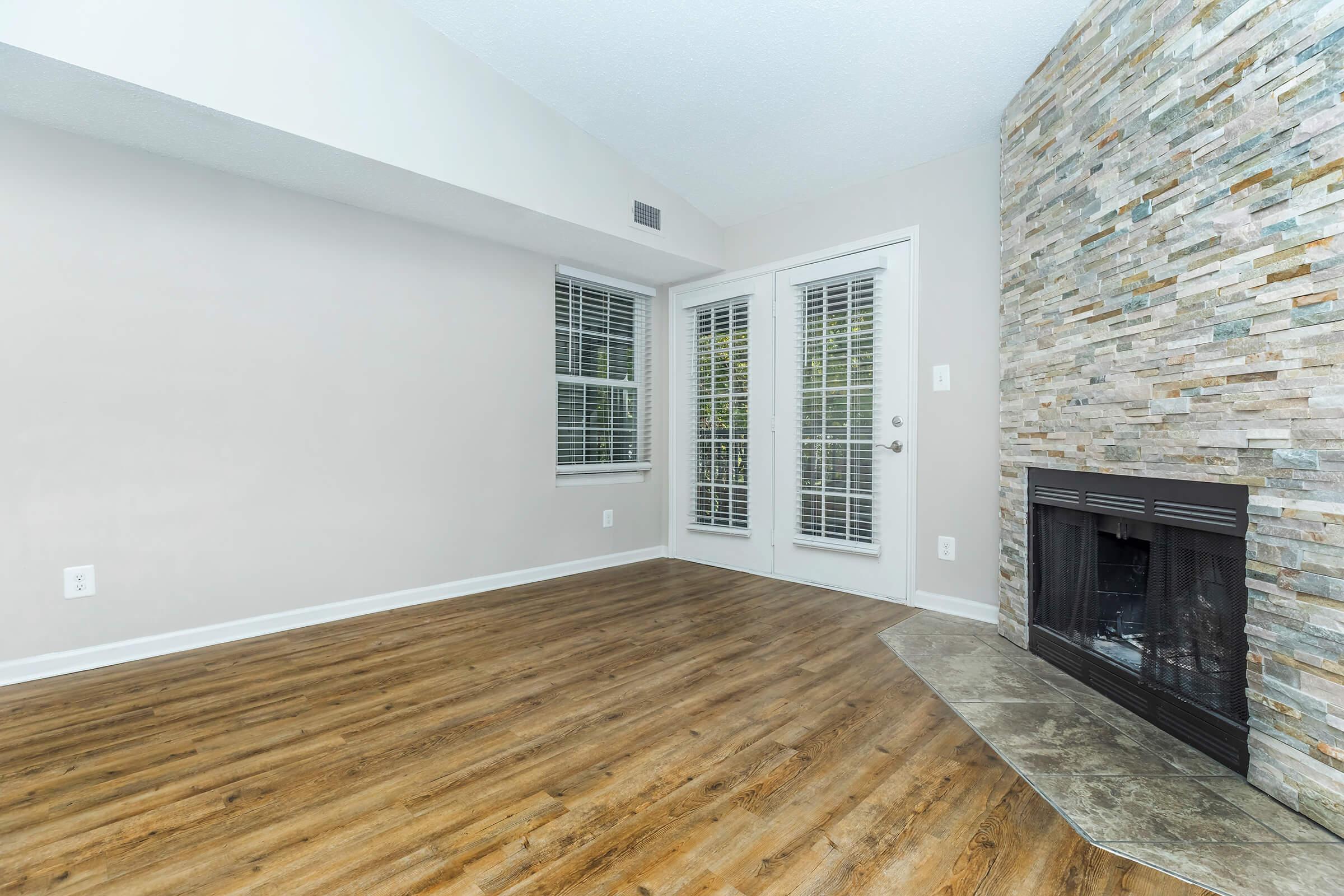 a living room with a fireplace and a large window