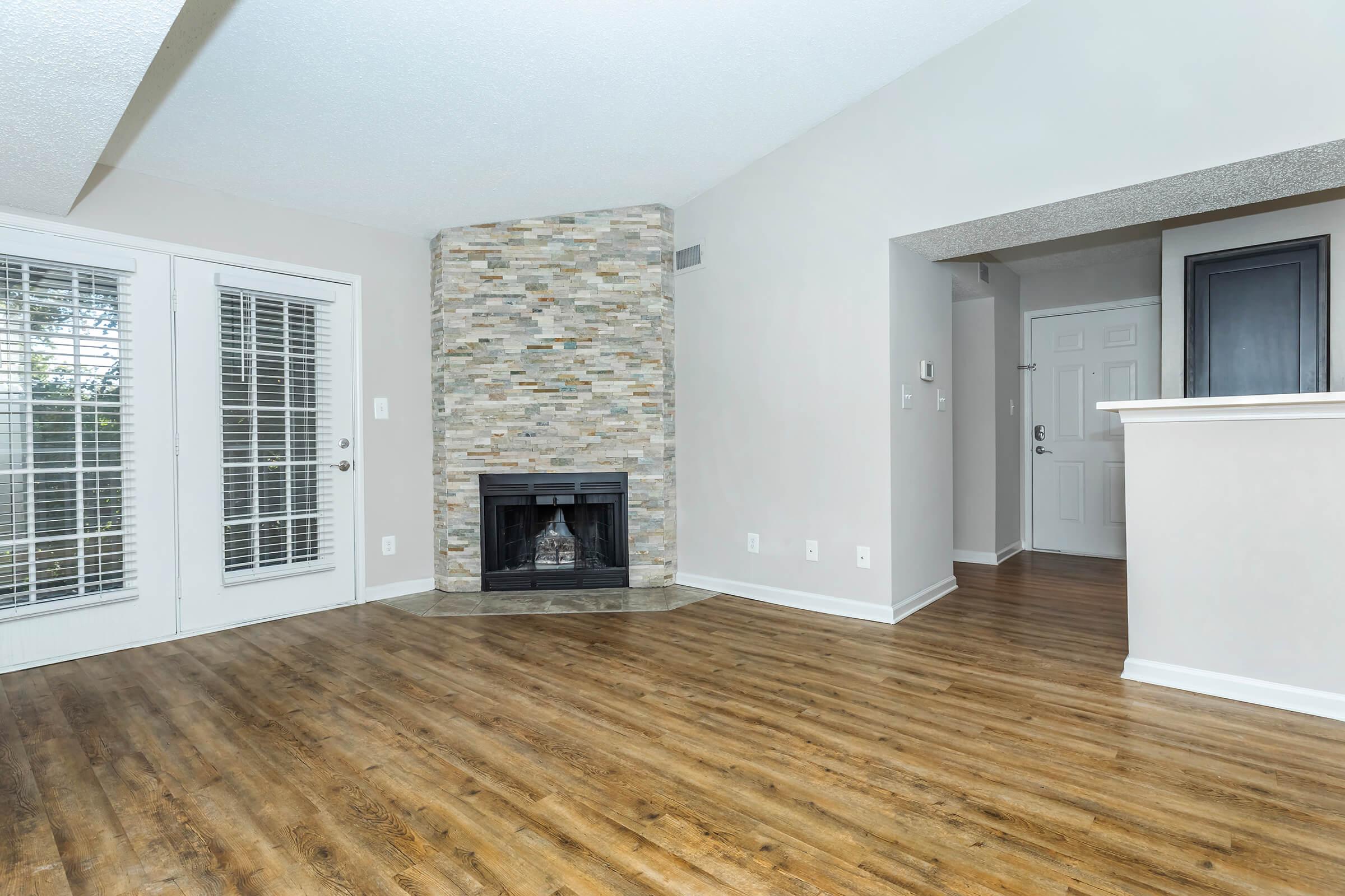 a living room filled with furniture and a large window