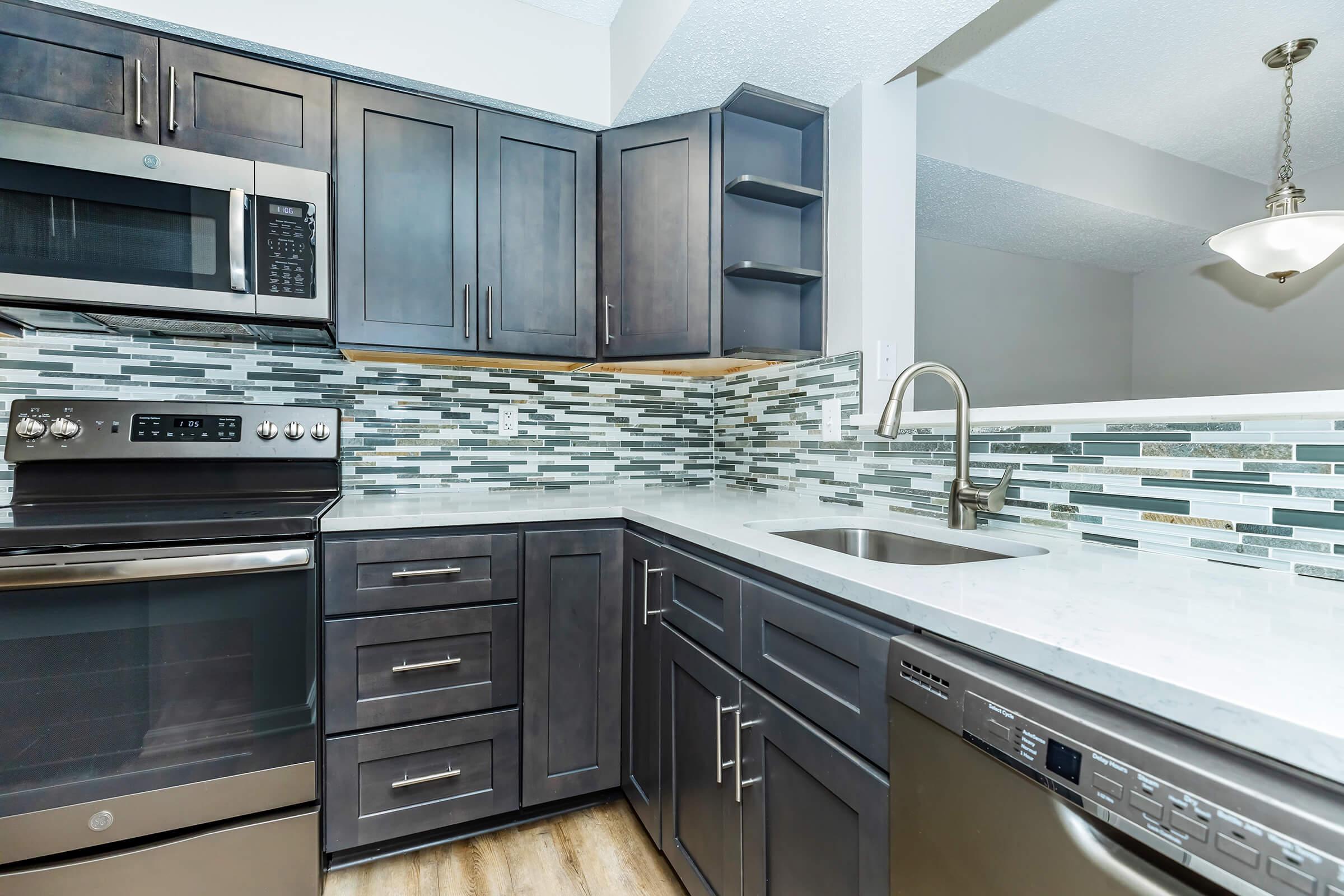 a stove top oven sitting inside of a kitchen