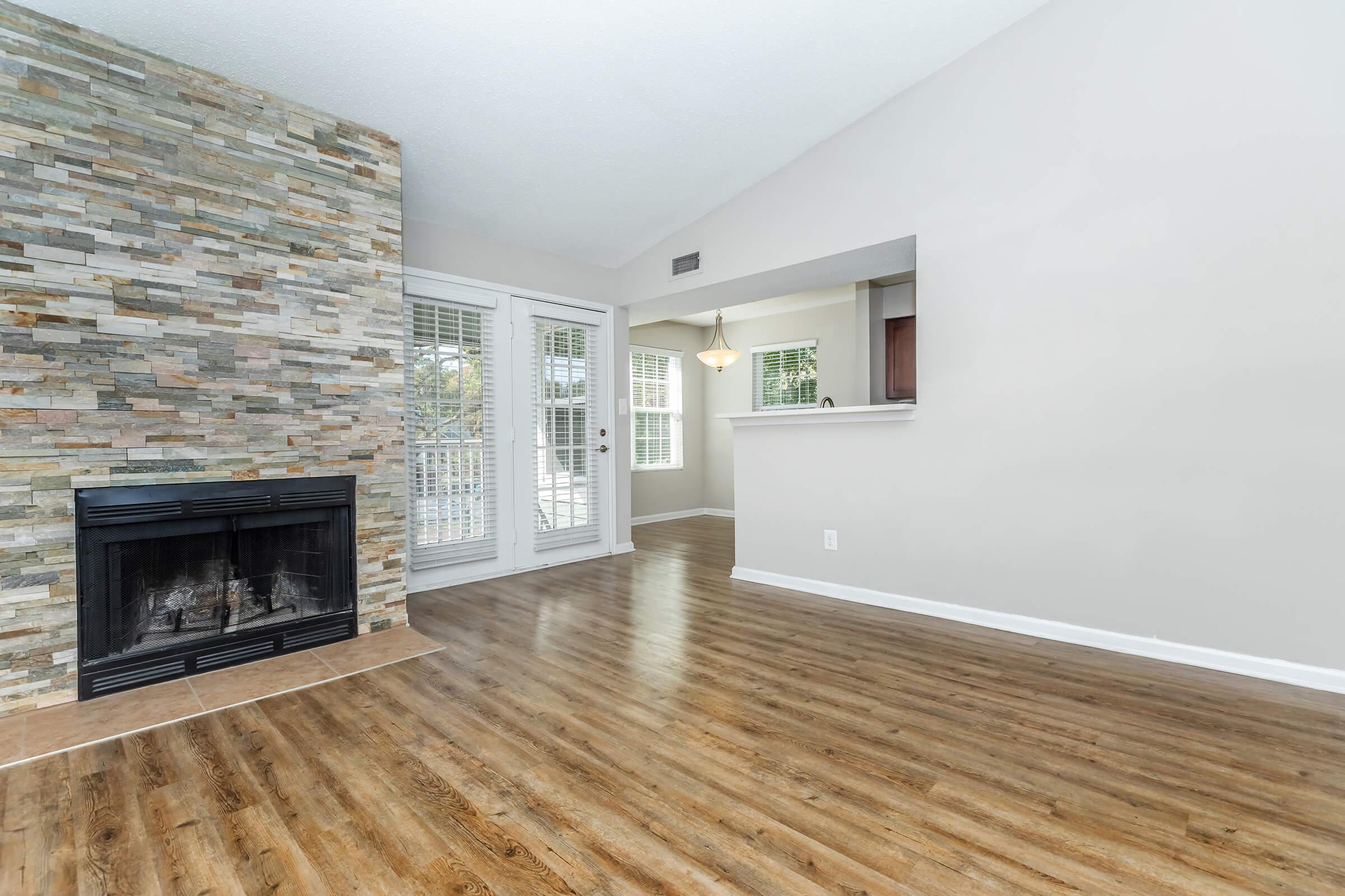 a living room filled with furniture and a fireplace