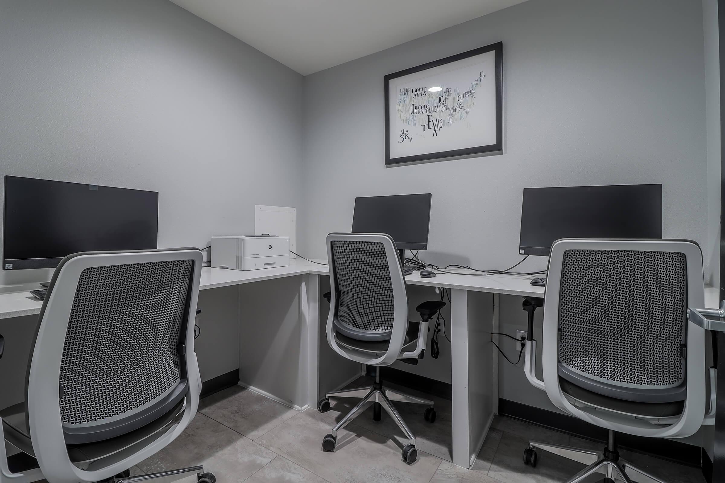 an office with a desk and chair in a room