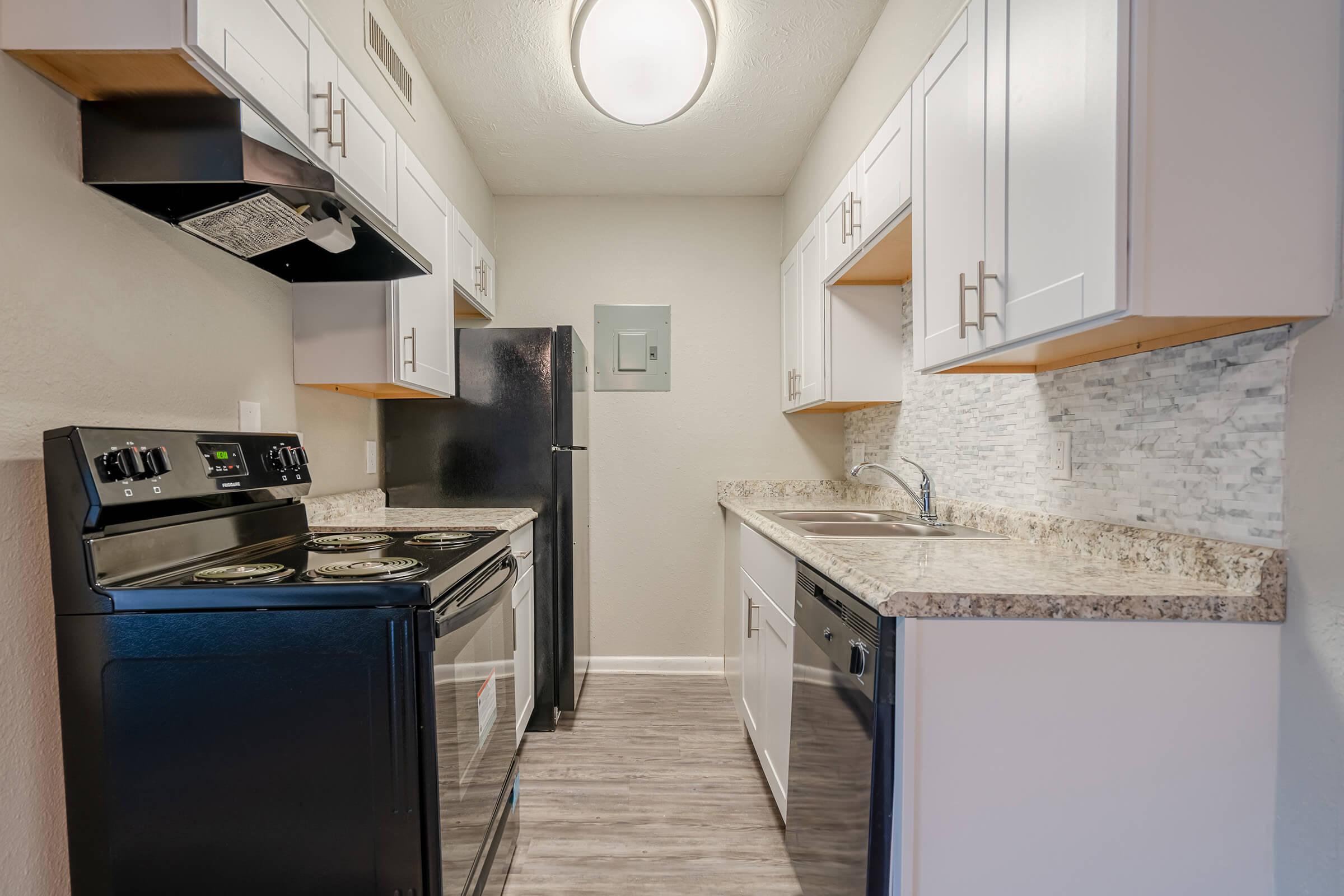 a kitchen with a stove top oven sitting inside of a refrigerator