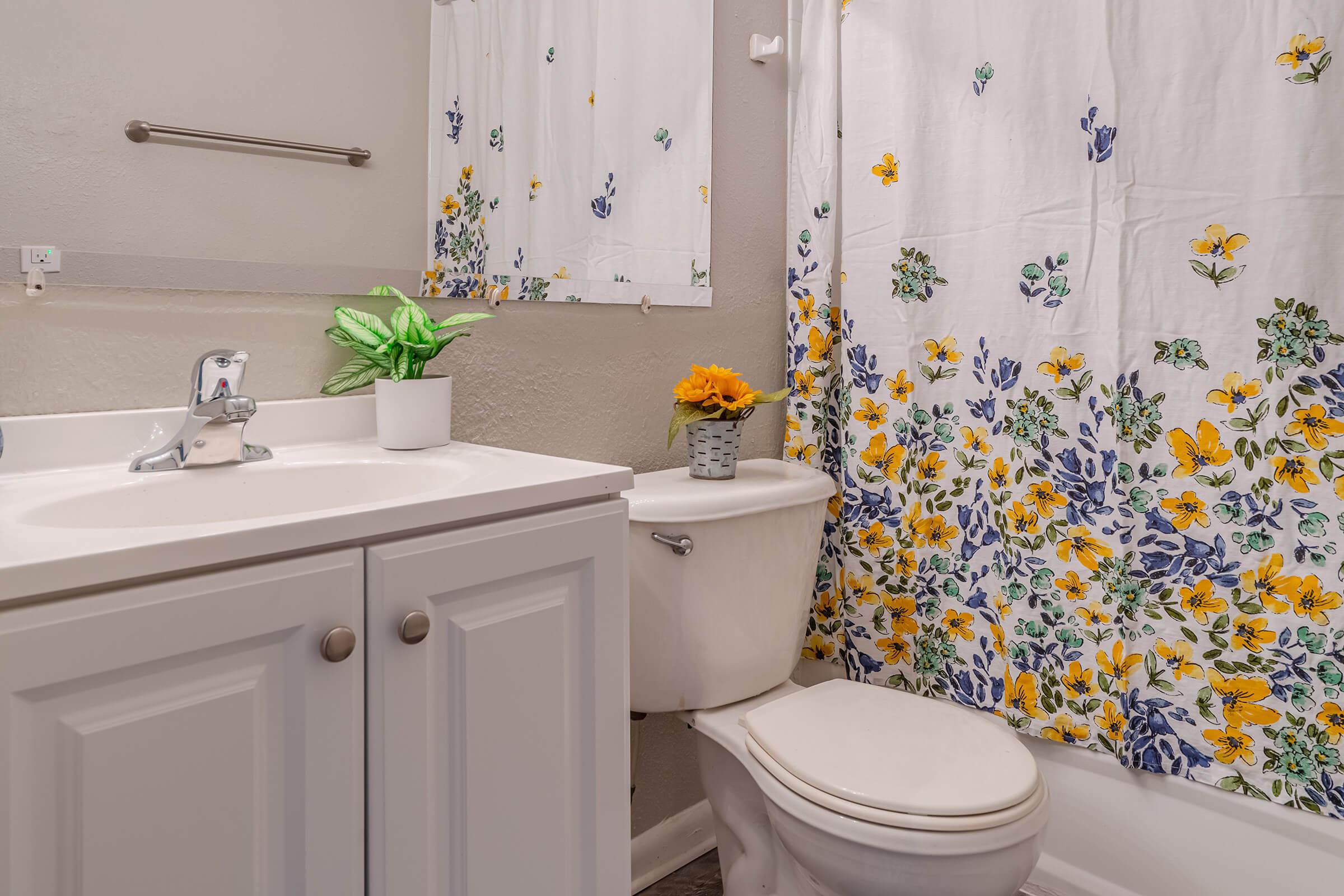 a white sink sitting next to a shower
