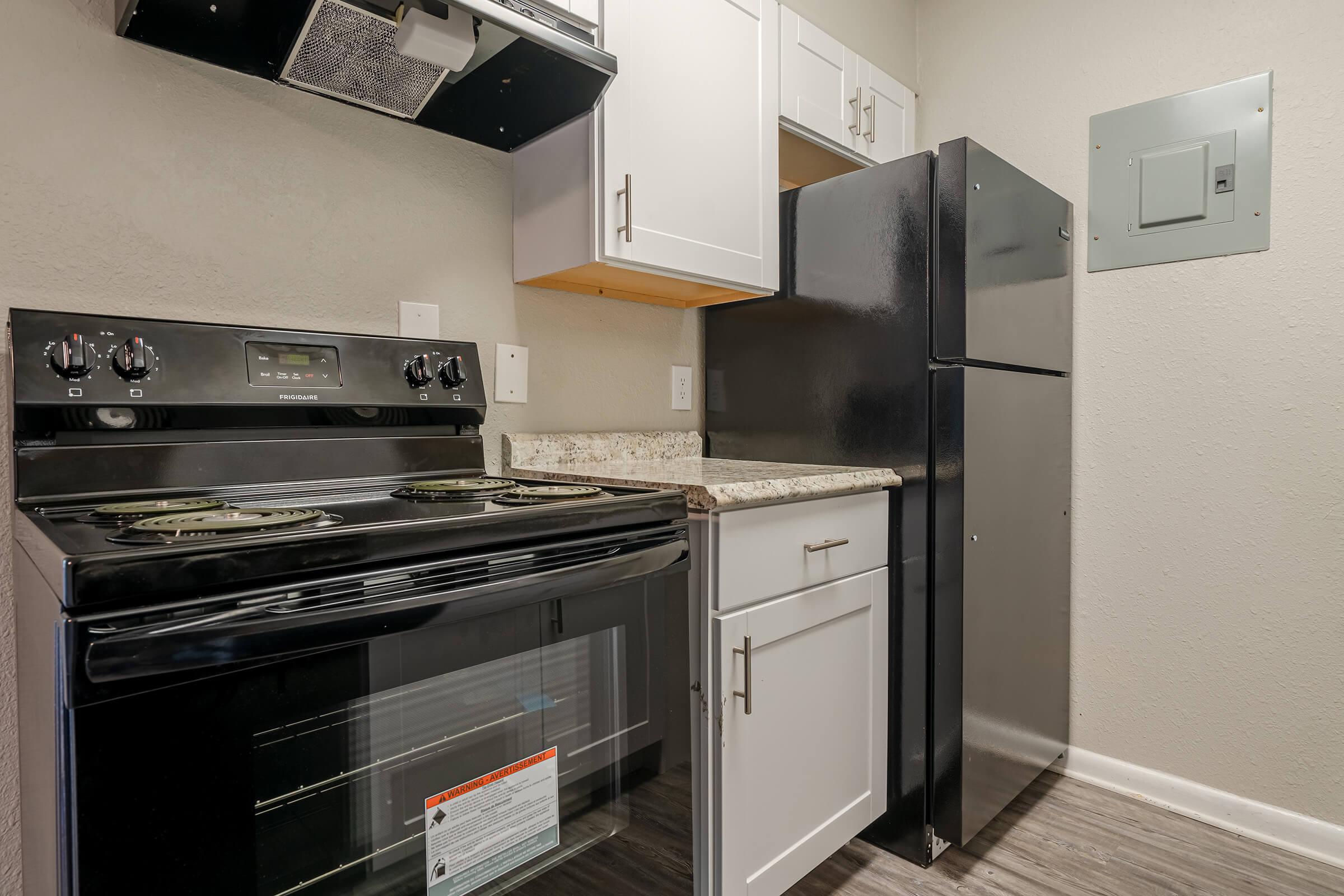 a stove top oven sitting inside of a kitchen