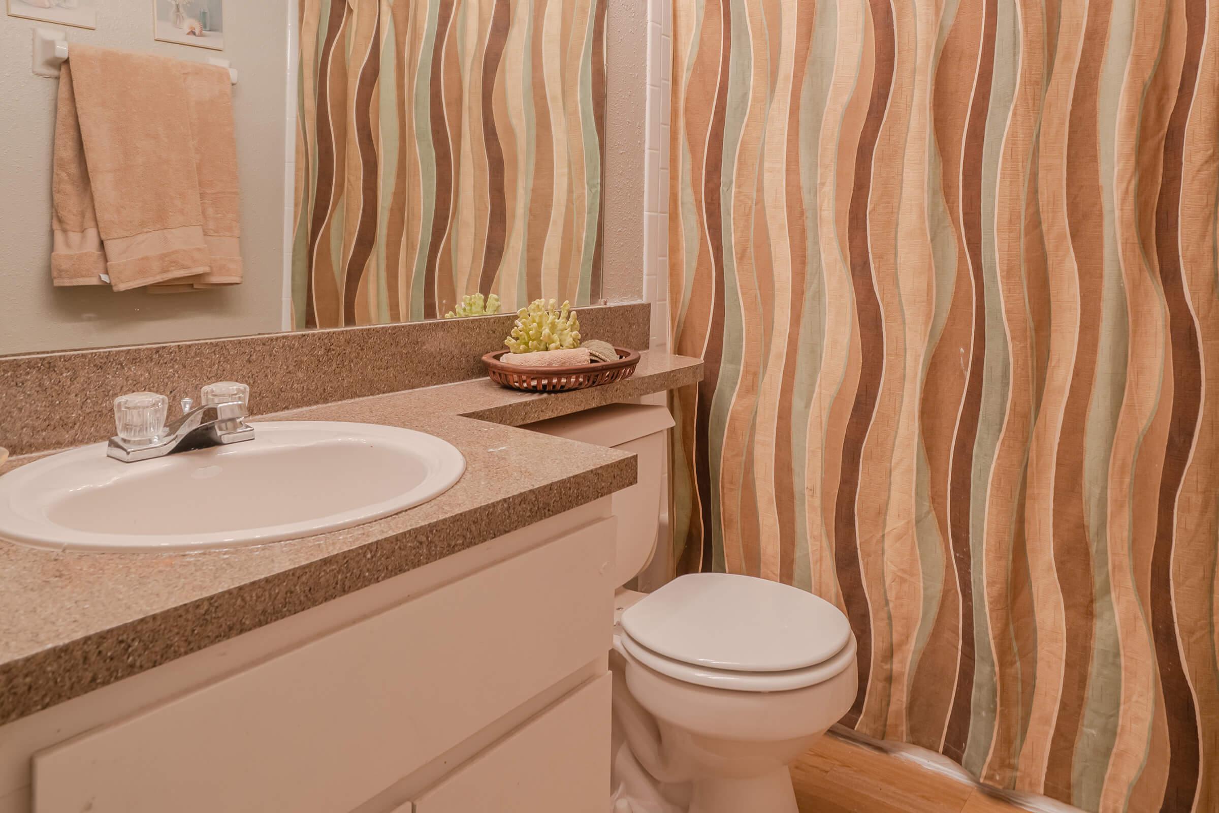 a white tub sitting next to a sink