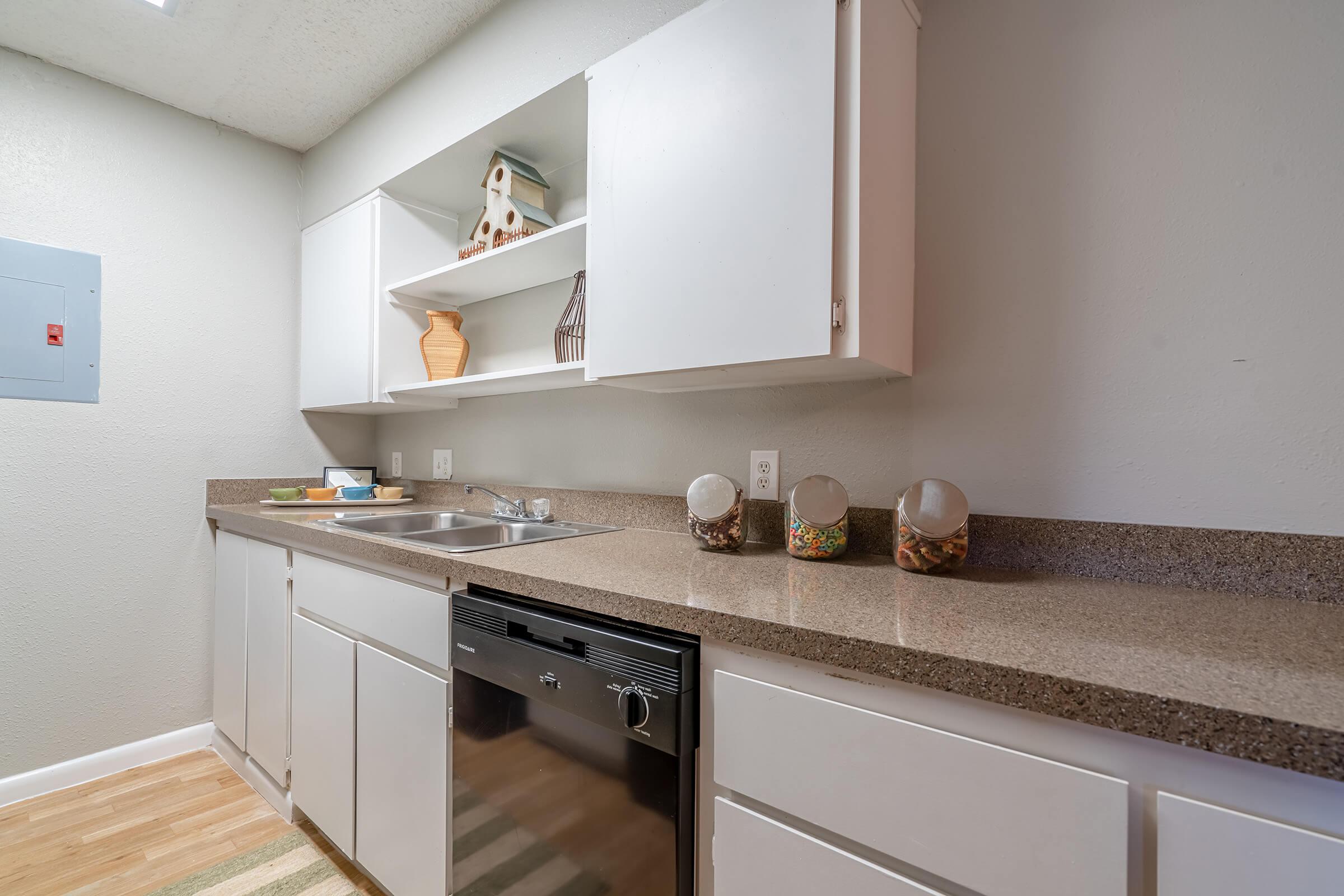 a kitchen with a sink and a mirror