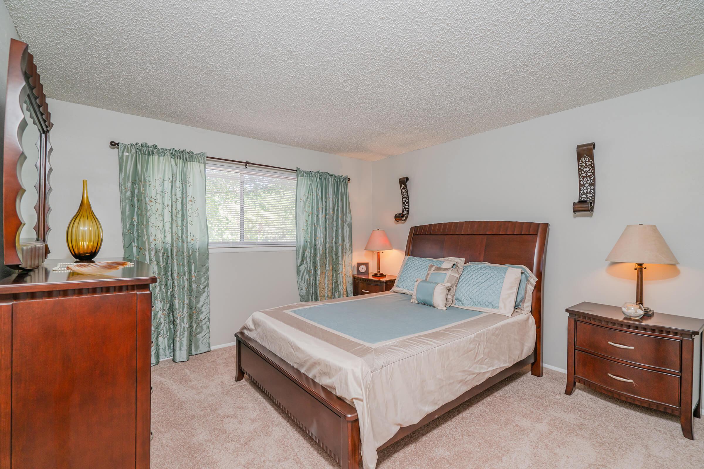 a bedroom with a bed in a room