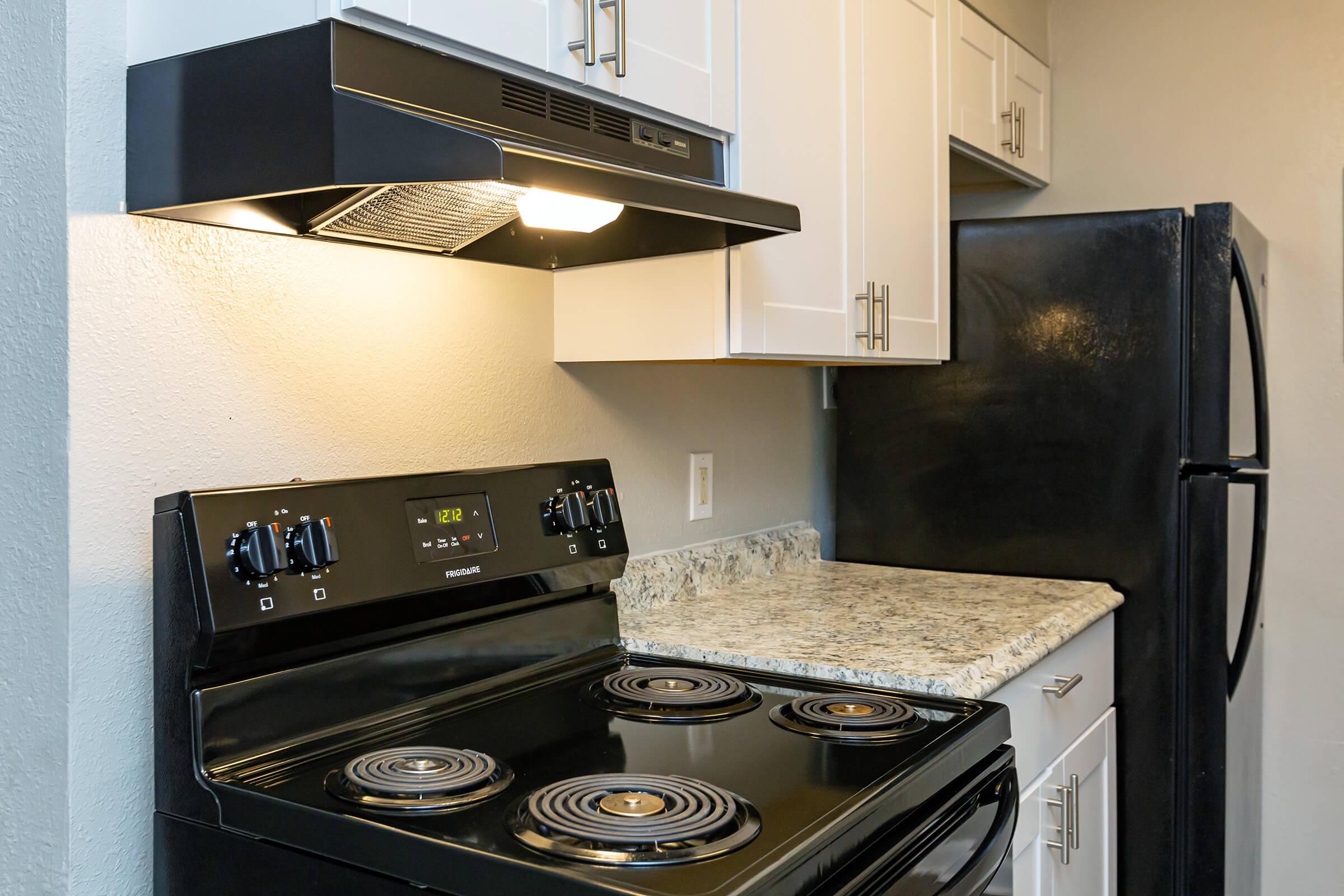 a stove top oven sitting inside of a kitchen
