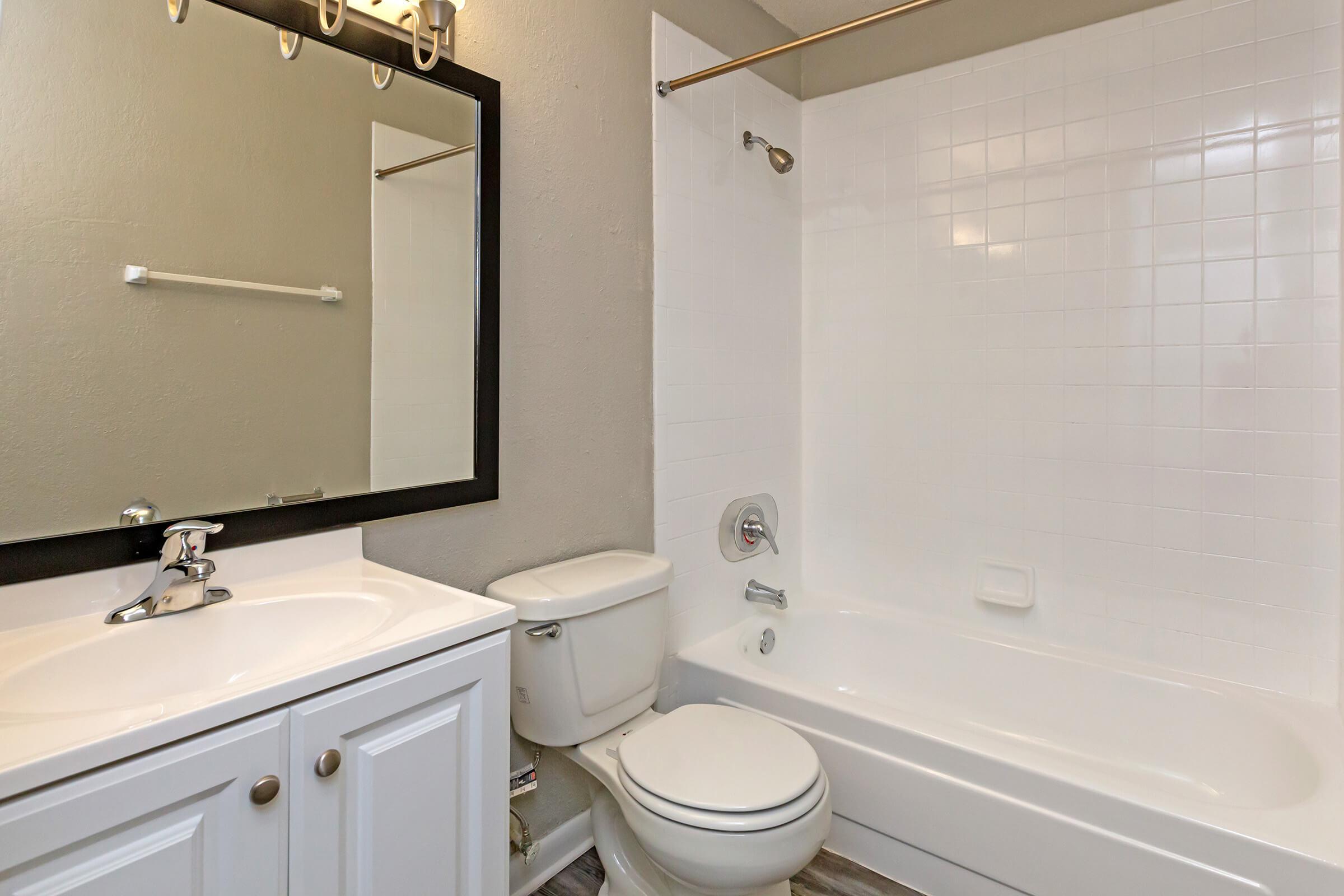 a white sink sitting next to a shower