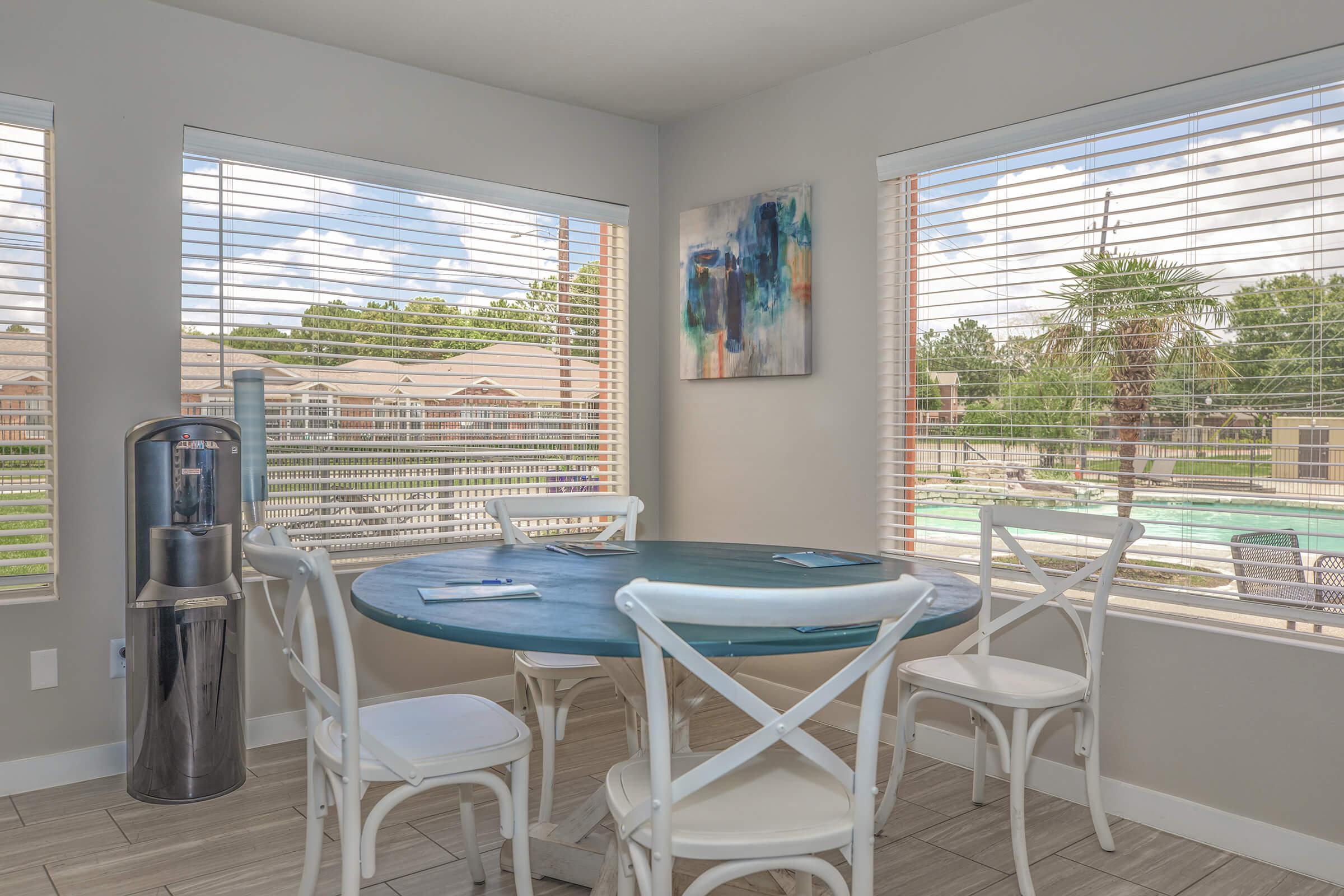a dining room table in front of a window
