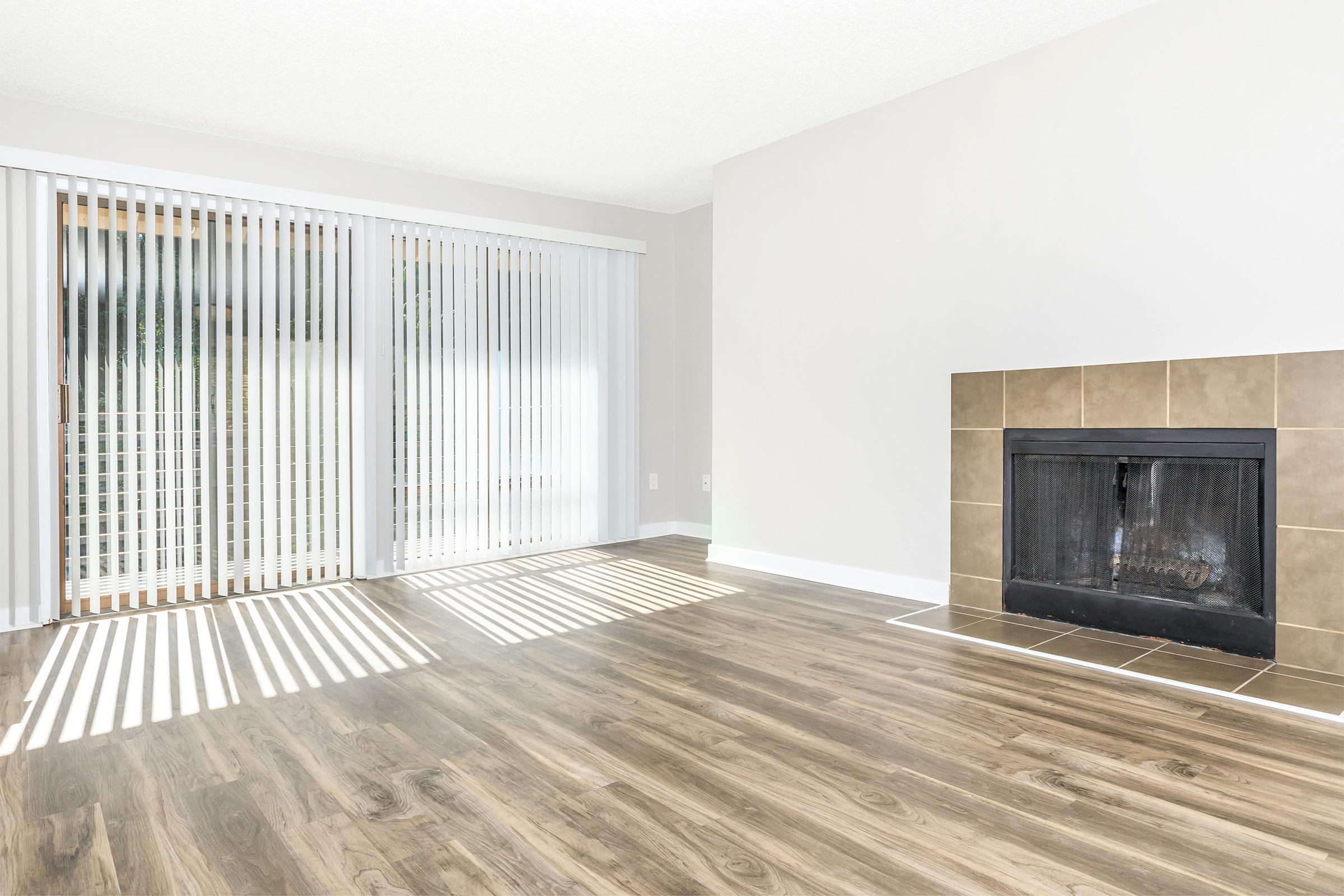 a living room filled with furniture and a fireplace