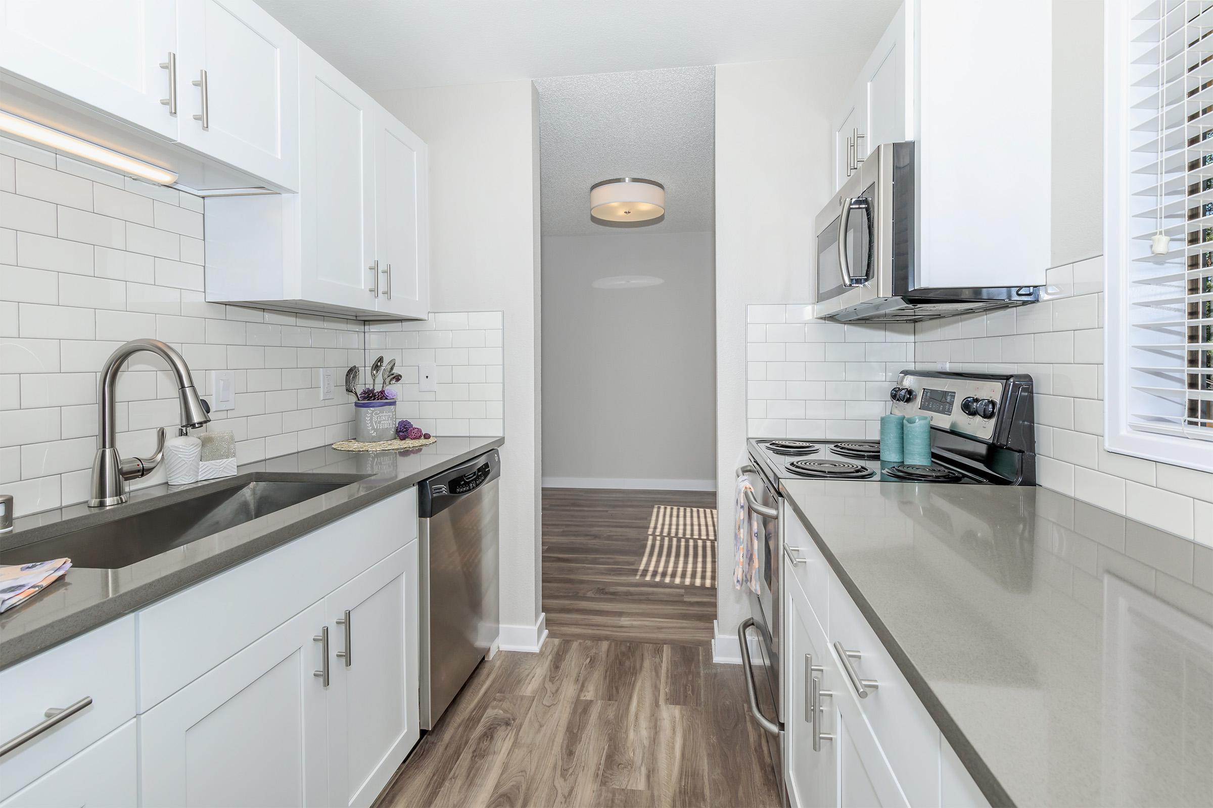 a kitchen with a sink and a window